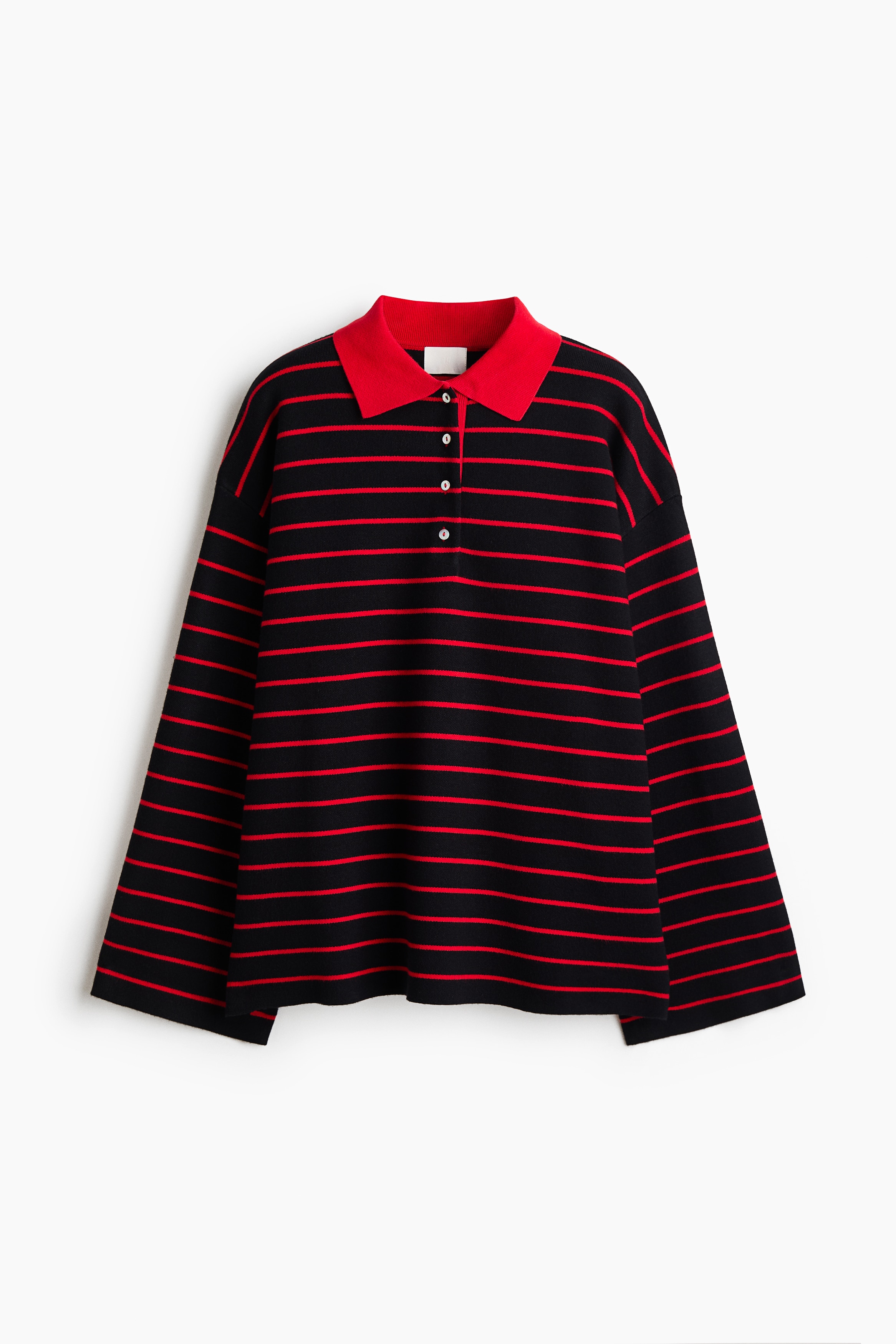 An oversized polo shirt is draped loosely in a front-facing view, featuring horizontal black and red stripes. The shirt displays dropped shoulders, wide long sleeves, and a contrasting solid red collar with an open, partially buttoned placket.