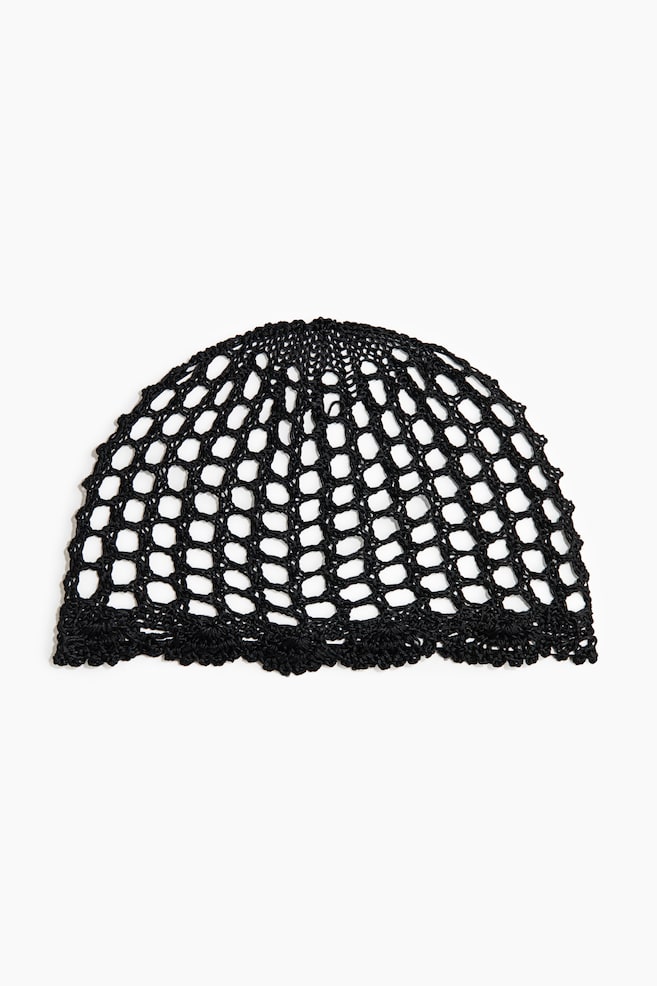 A black crocheted cap is displaying a wide mesh pattern and featuring a decorative, scalloped border along its lower edge. - 1