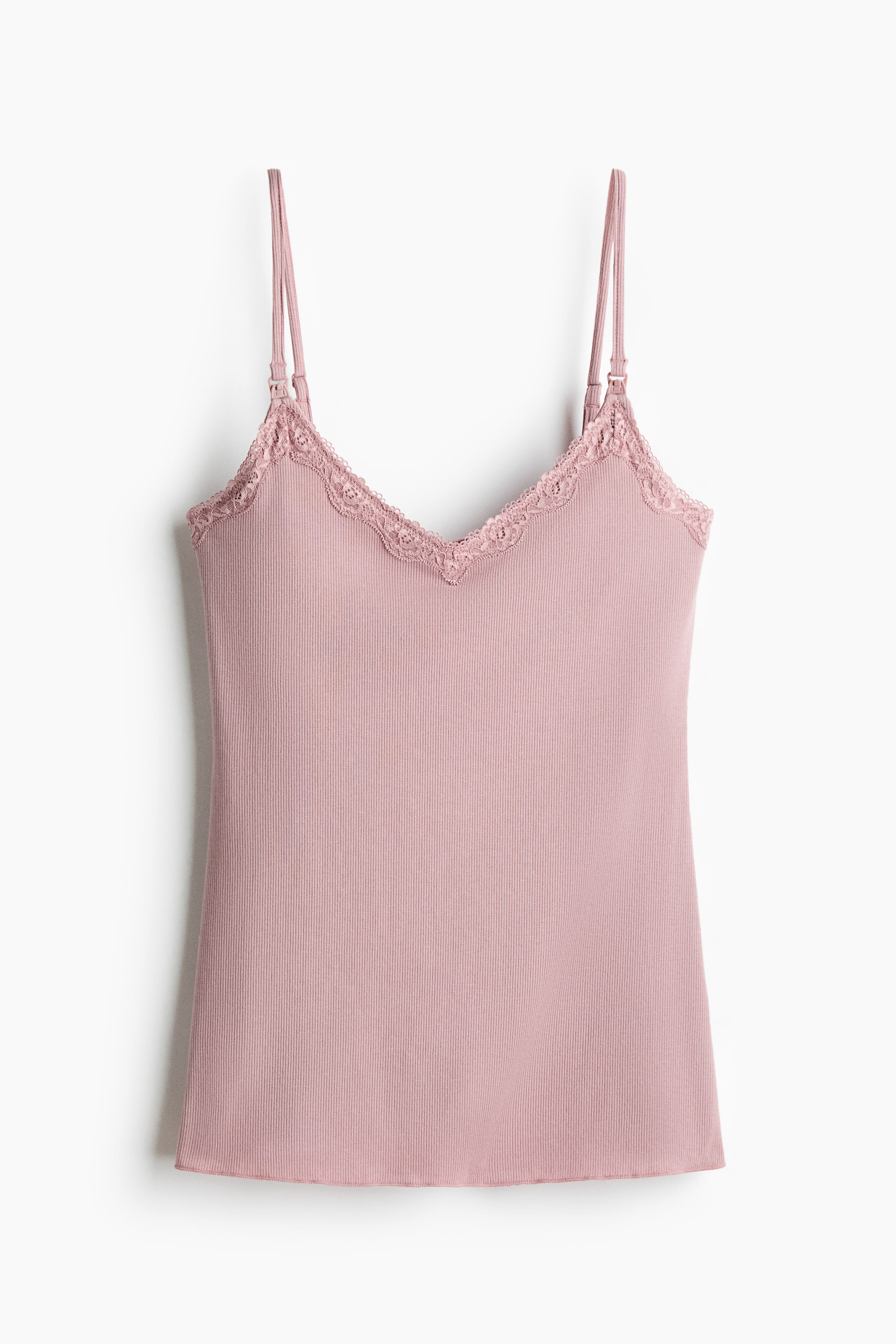 View larger image: A pink fitted nursing top is shown front, featuring a ribbed jersey texture, a lace-trimmed V-neckline, and narrow, adjustable shoulder straps with functional fastenings.