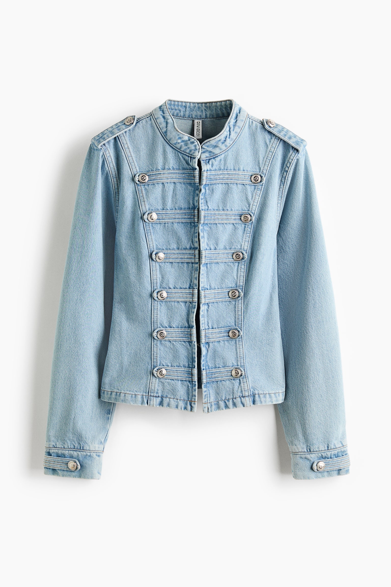A light blue denim jacket is facing front, featuring a stand-up collar and epaulettes, each displaying a silver-toned button. The front panel showcases five horizontal bands of denim, each adorned with two silver-toned decorative buttons on either side of the centre opening, while long sleeves end in single-button cuffs. - 1