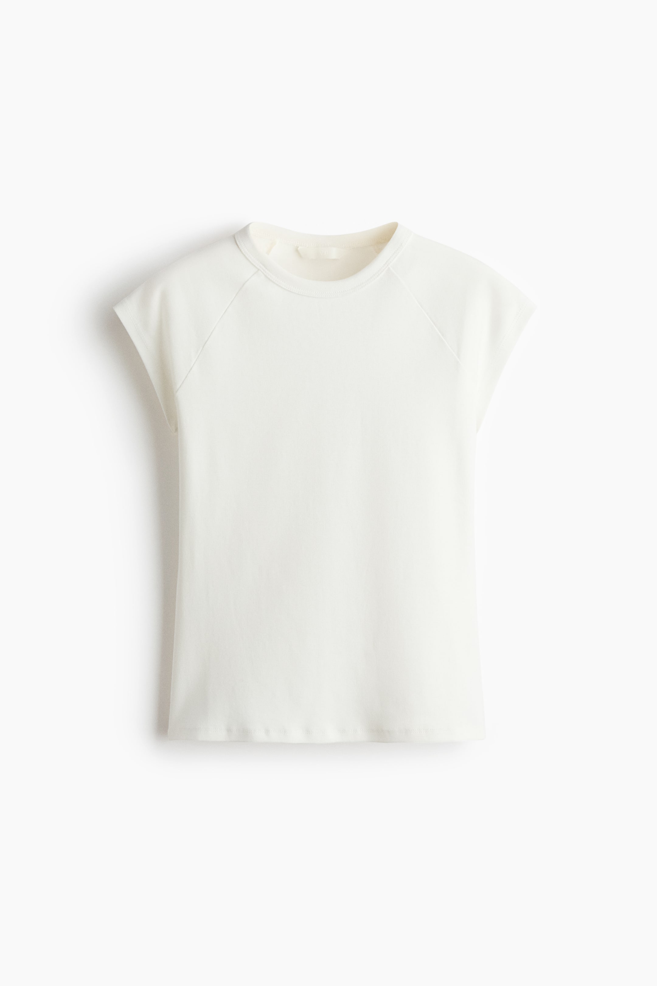 View larger image: An ecru cap-sleeve t-shirt is showcased from the front. It features a round neckline with a visible inner tag and raglan seams extending to the underarms.