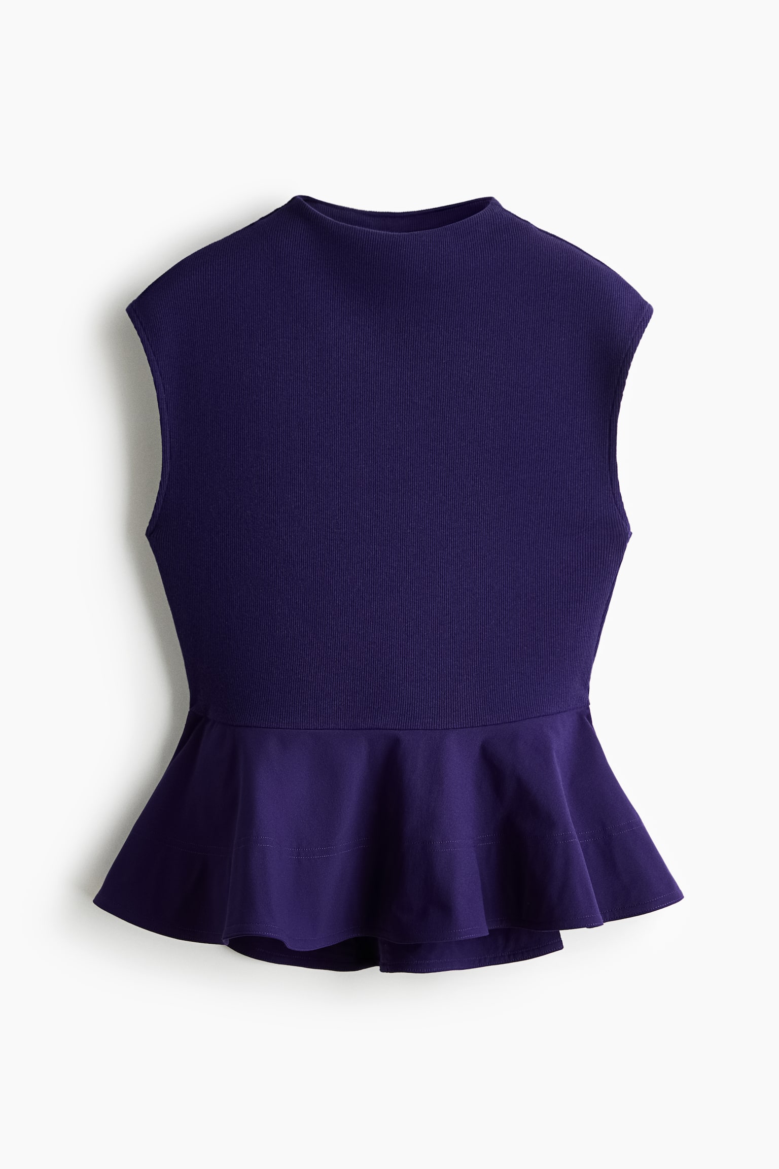 A dark purple sleeveless top is shown from the front, featuring a high mock neck, a fine-ribbed knit bodice, and a flared peplum hem.