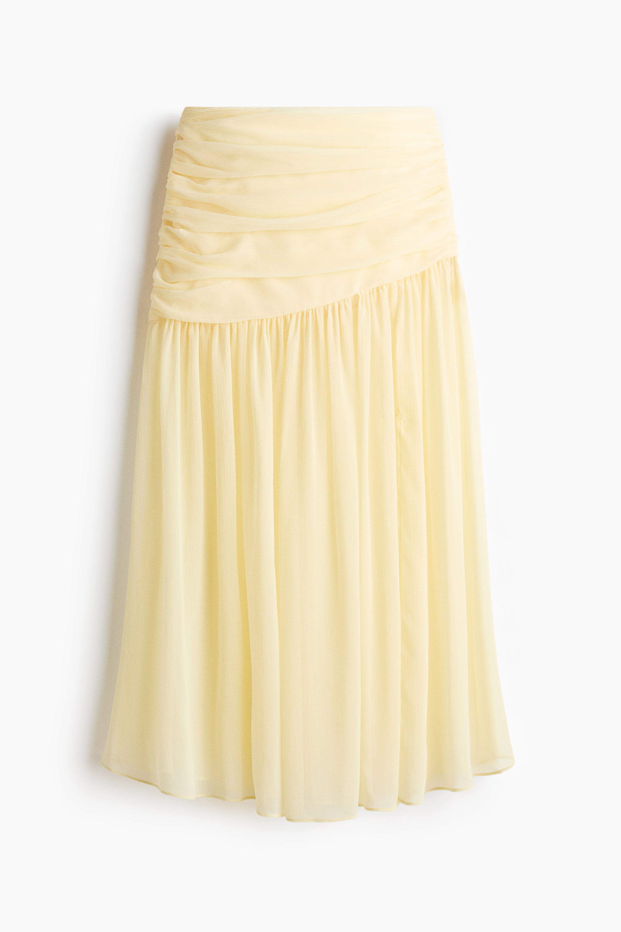 View larger image: A pale yellow sheer maxi skirt is showcased at the front. Its upper section is ruched, and the lightweight fabric cascades into soft gathers down to the hem.