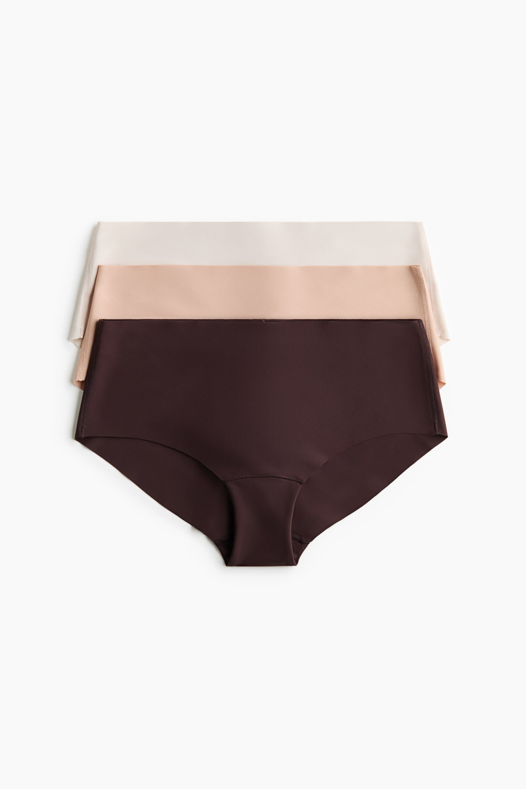 View larger image: Three pairs of briefs are stacked, facing front, showcasing a mid-waist design with smooth, seamless edges. The top pair is a light beige, the middle pair is a light brown, and the bottom pair is a dark brown.