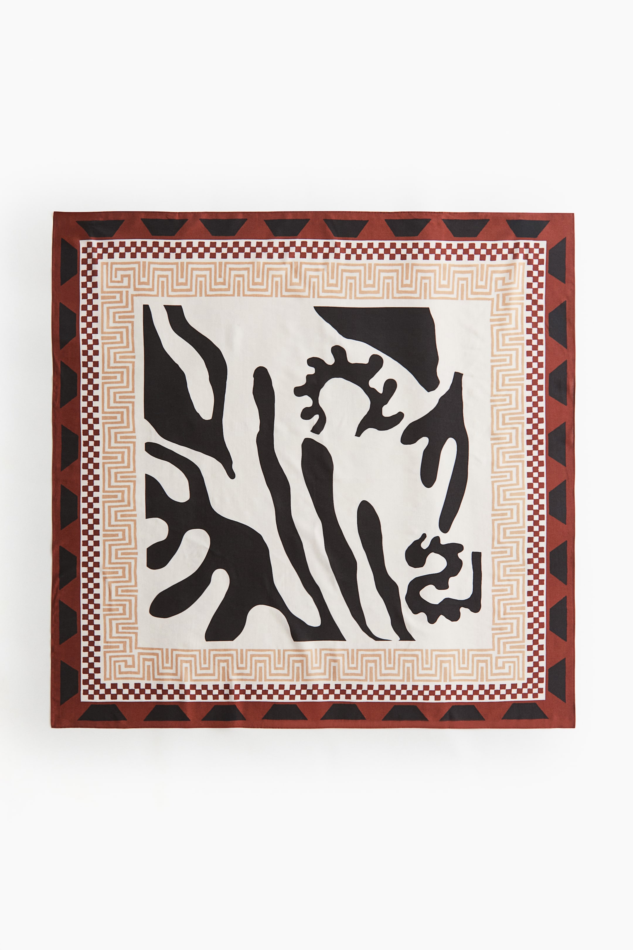 View larger image: A square scarf in a soft weave is presenting a printed pattern, featuring a central off-white field with irregular black abstract shapes. This central design is framed by multiple borders: a tan geometric pattern, a brown and off-white checkered band, and an outermost reddish-brown band with black triangular elements.