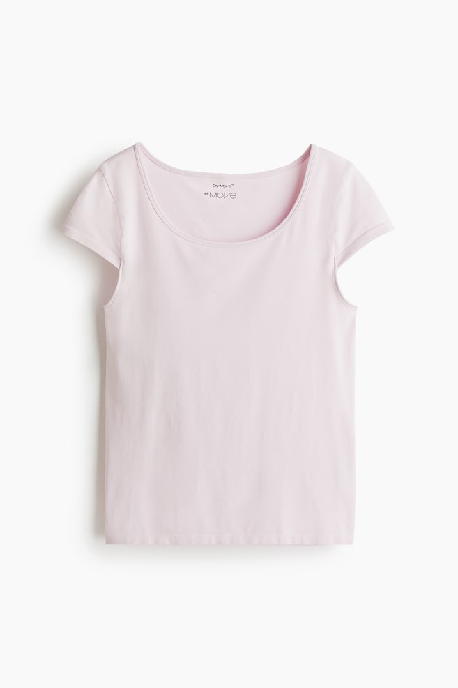 A light pink short-sleeved top is lying flat, showcasing its front. It is featuring a wide scoop neckline with a narrow binding and short, cap sleeves. - 1