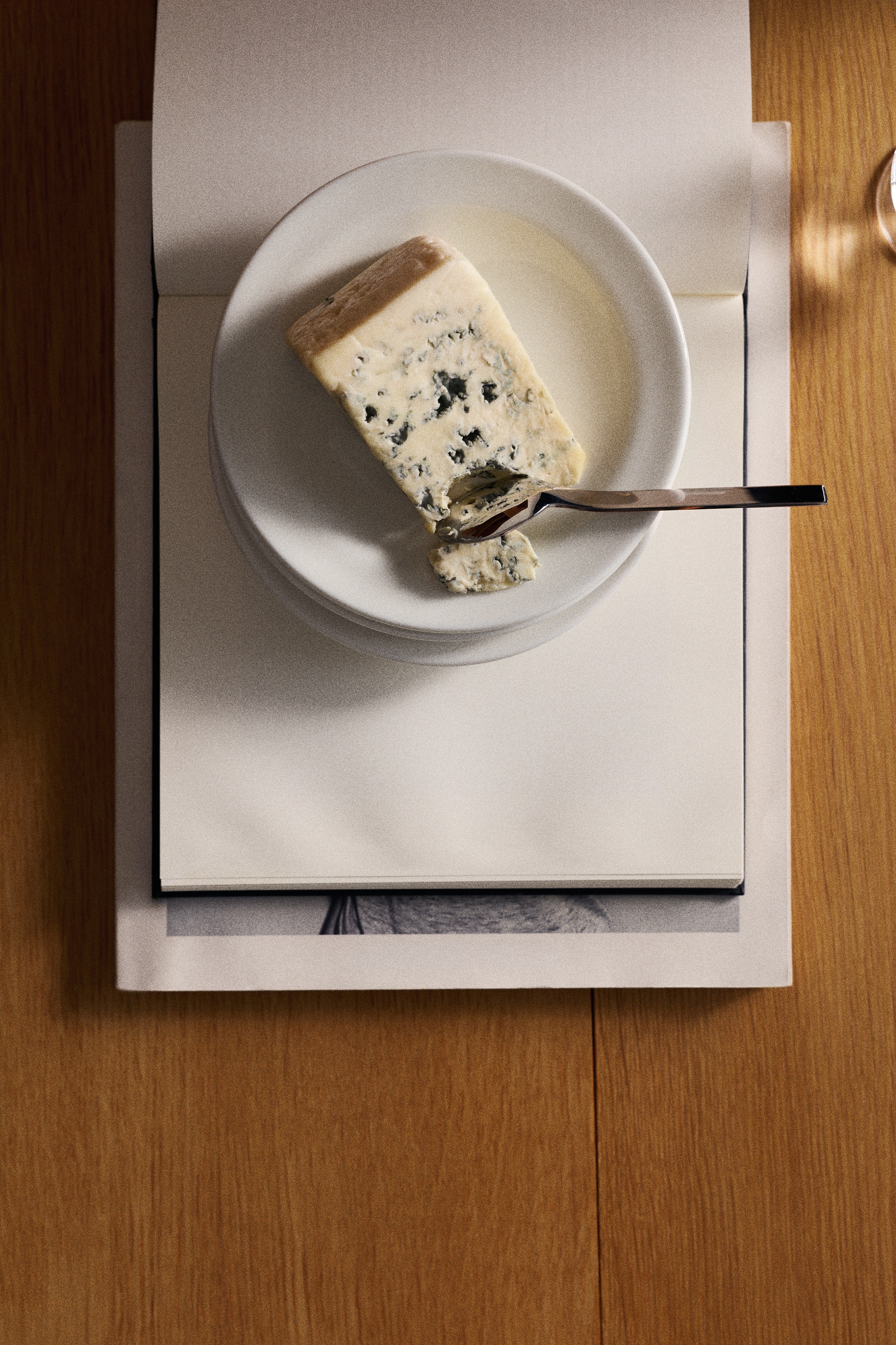 Two round, off-white plates are presented flat, facing upwards. Each plate is designed with a slightly raised rim and a smooth, flat centre.