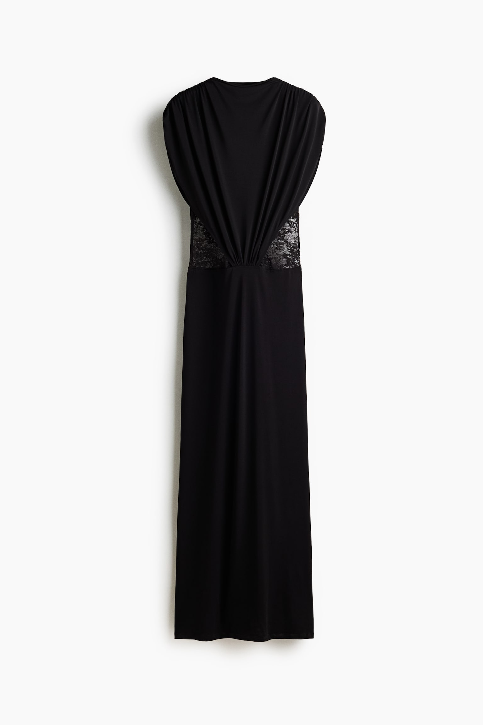 A black sleeveless maxi dress is shown from the front, featuring a draped bodice that gathers at the centre waist and sheer lace inserts along the sides. The dress falls into a straight, floor-length skirt with a high round neckline.