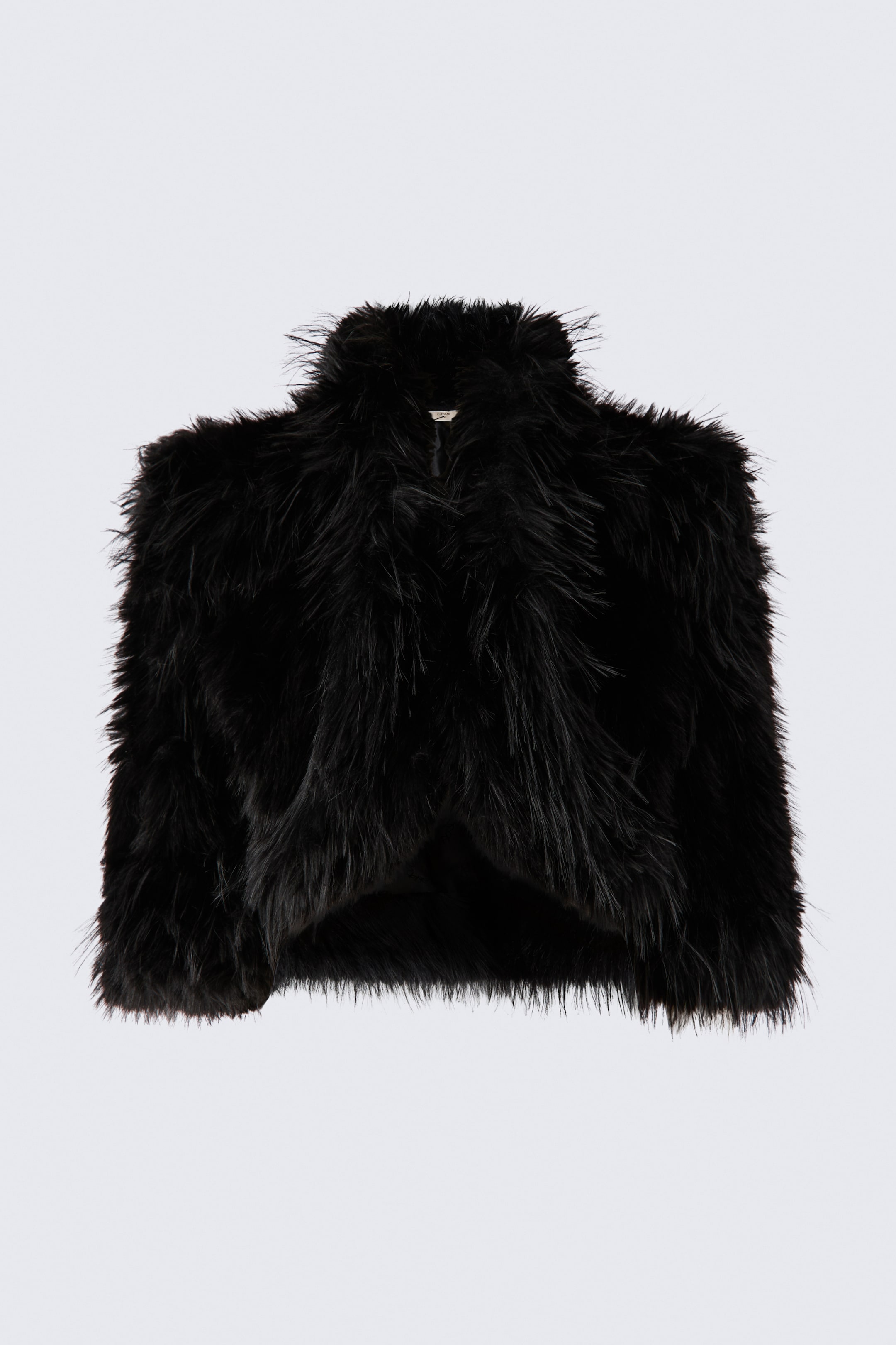 View larger image: The black fluffy jacket showcases a cropped, structured silhouette with padded shoulders and an open front, viewed from the front. It features long, shaggy faux fur across the entire exterior, including the high collar and long sleeves.