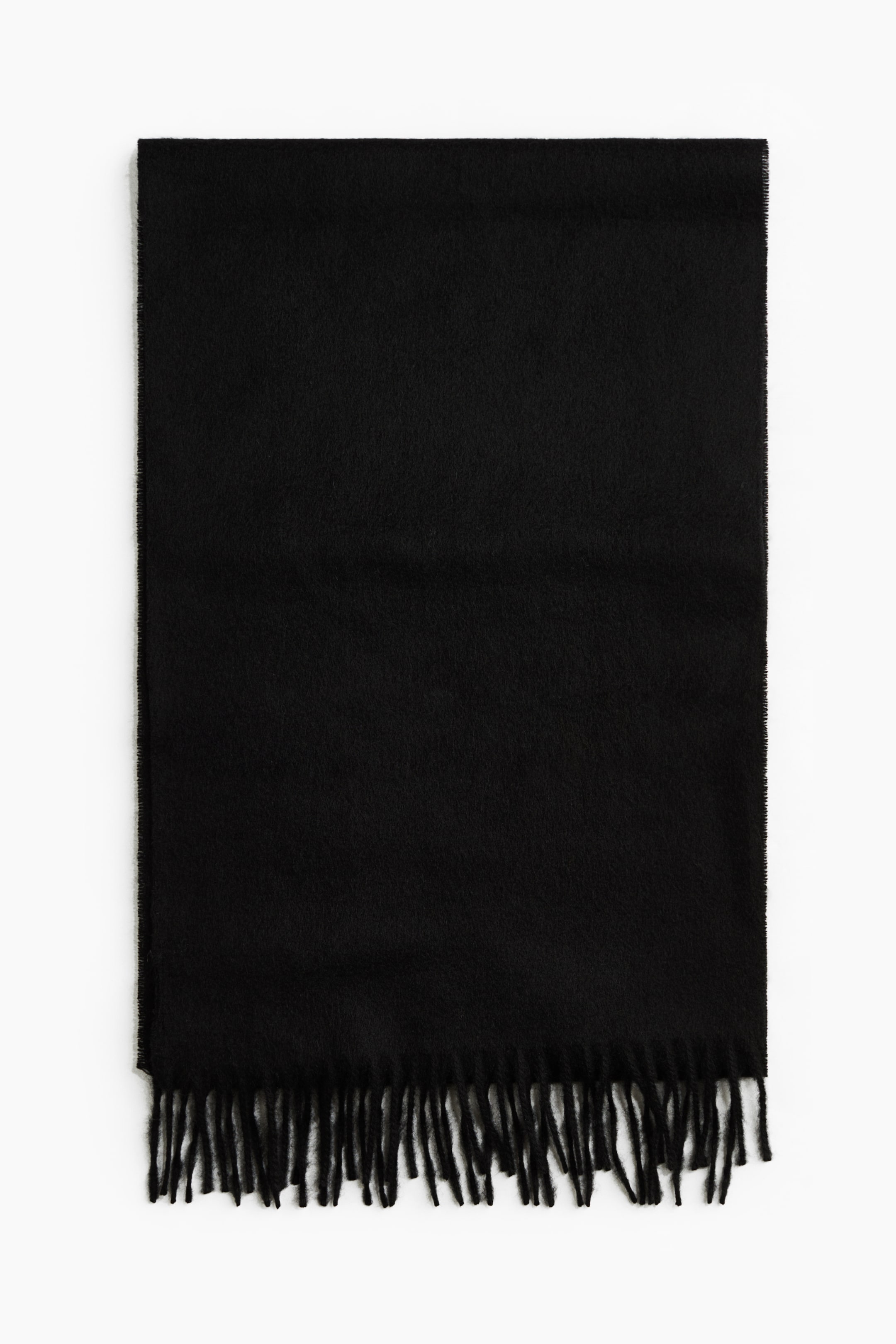 View larger image: A black cashmere scarf is shown from the front, laid flat to display its soft woven texture and twisted fringes along the bottom short edge.
