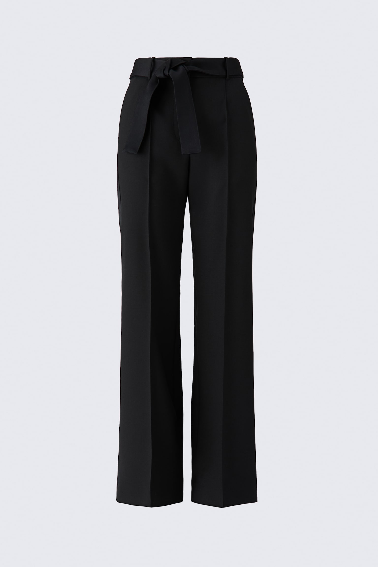 These black tie-detail wool trousers are shown from a front-facing angle, featuring a high-waisted fit with a matching fabric belt tied at the front. The design features straight, wide legs with sharp pressed creases running down the centre of each leg.