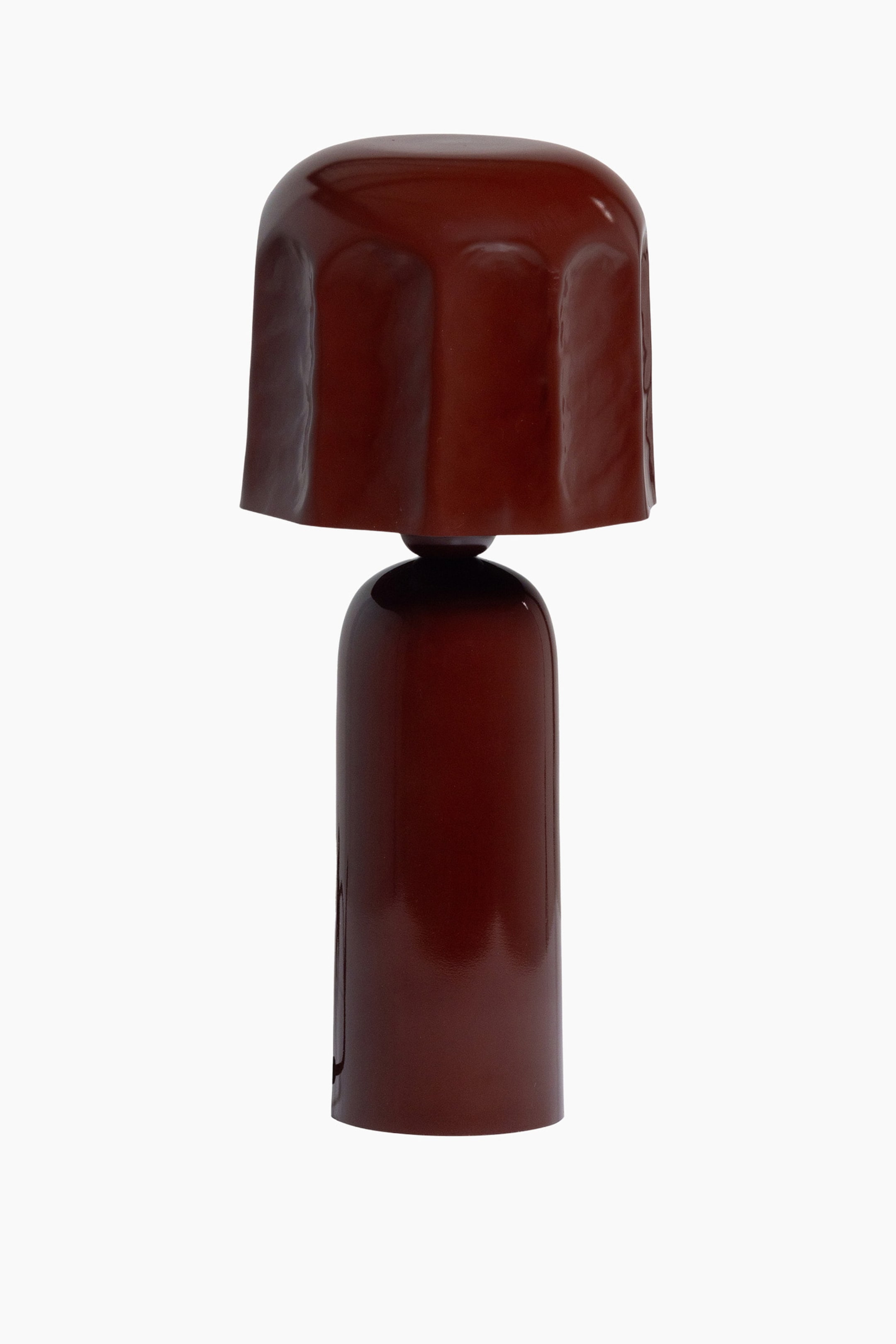Ver imagen más grande: Un objeto brillante de color marrón rojizo oscuro está de pie, con una sección superior ancha y redondeada que presenta paneles verticales sutilmente curvados, descansando sobre una base cilíndrica más estrecha y conectada por un pequeño elemento esférico oscuro.