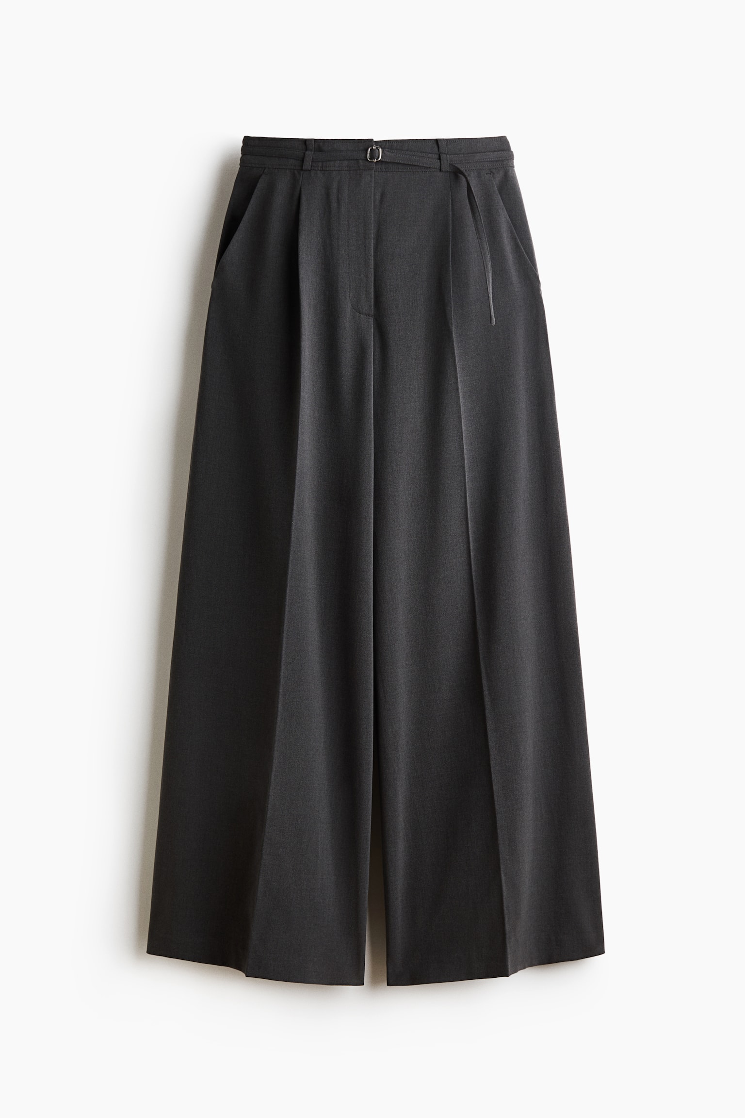 These dark grey, wide-leg tailored trousers are shown from the front, featuring a high waist with a slim, adjustable belt and diagonal side pockets. The relaxed-fit trousers display sharp pressed creases running down the centre of each wide leg.