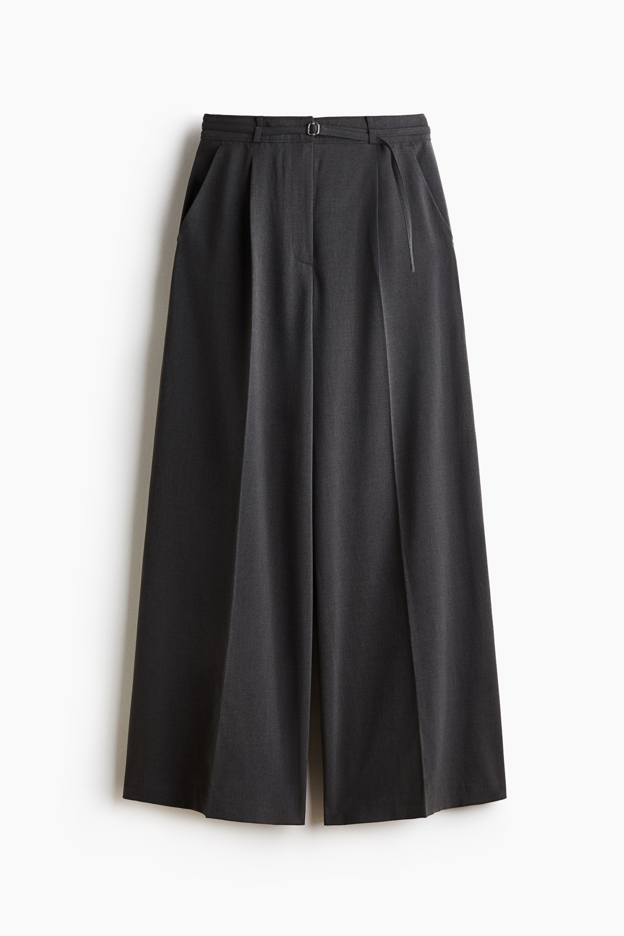 View larger image: These dark grey, wide-leg tailored trousers are shown from the front, featuring a high waist with a slim, adjustable belt and diagonal side pockets. The relaxed-fit trousers display sharp pressed creases running down the centre of each wide leg.
