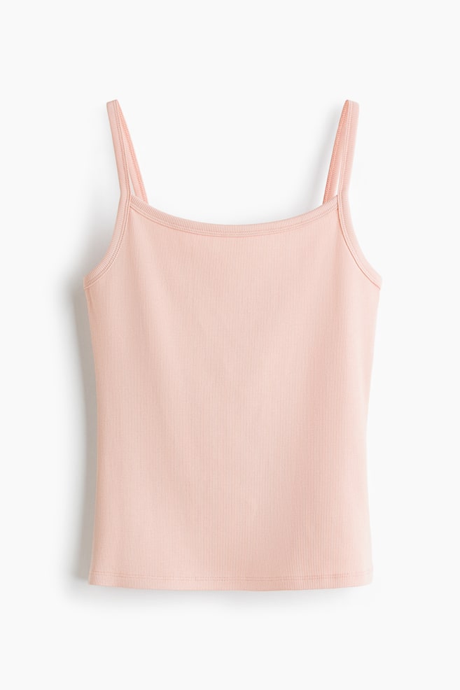 A light pink ribbed camisole is presenting front-facing, featuring thin spaghetti straps and a rounded square neckline. - 1