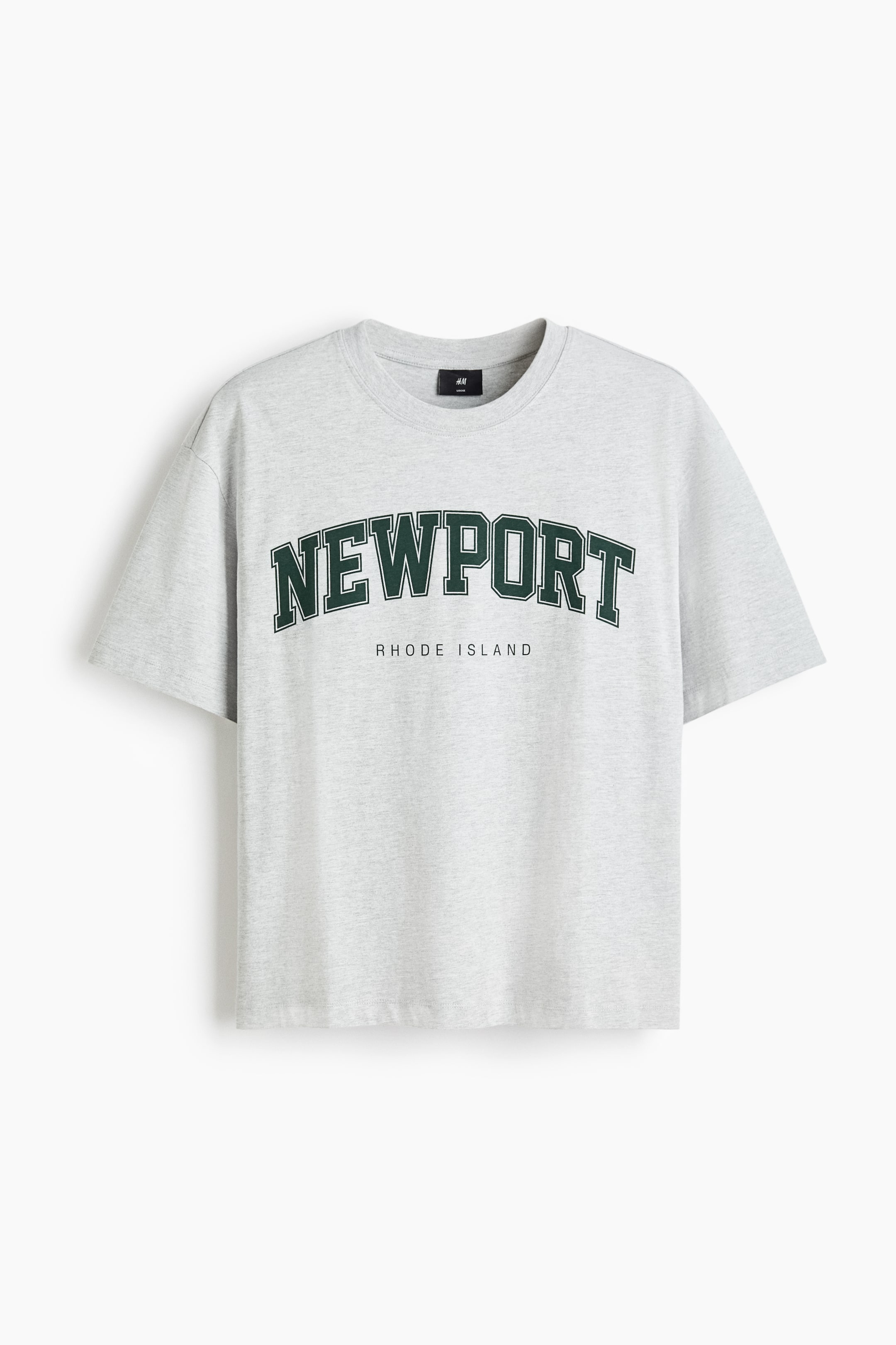 View larger image: A light grey, boxy-style T-shirt is shown from the FRONT, featuring a ribbed crew neck, dropped shoulders, and a straight-cut hem. The T-shirt is displaying "NEWPORT" in dark green arched lettering with a white outline, and "RHODE ISLAND" below it in smaller dark green text.