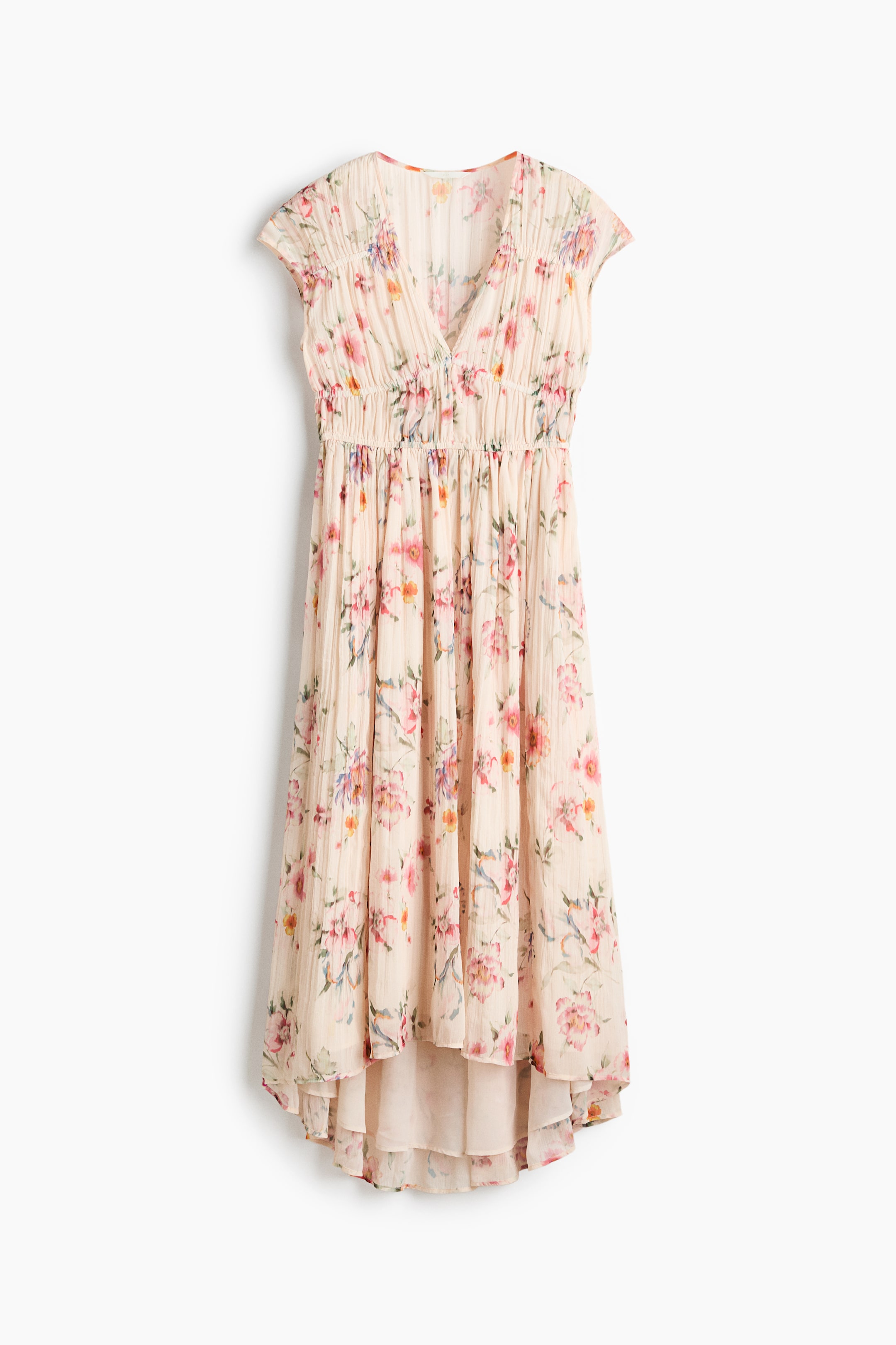 View larger image: The light beige floral print dress showcases a V-neckline, short cap sleeves, and a shirred elasticated waist. Its textured skirt is designed with a high-low hem and a visible lining.