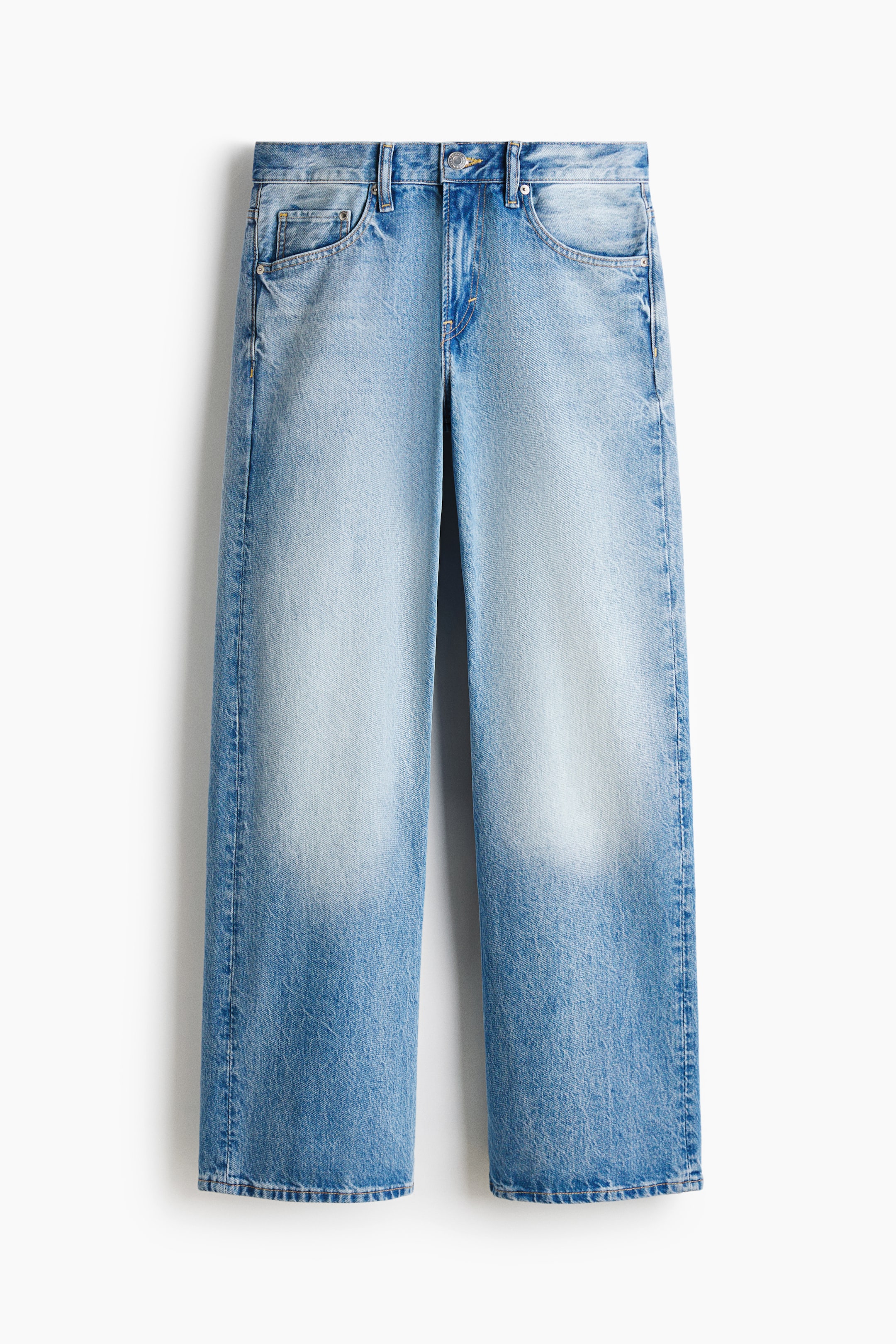 View larger image: Light blue jeans are facing forward, featuring a gradient faded wash from the upper thighs down and a straight, wide-leg cut. They are designed with a button and zipper fly, belt loops, two curved front pockets, and a coin pocket.