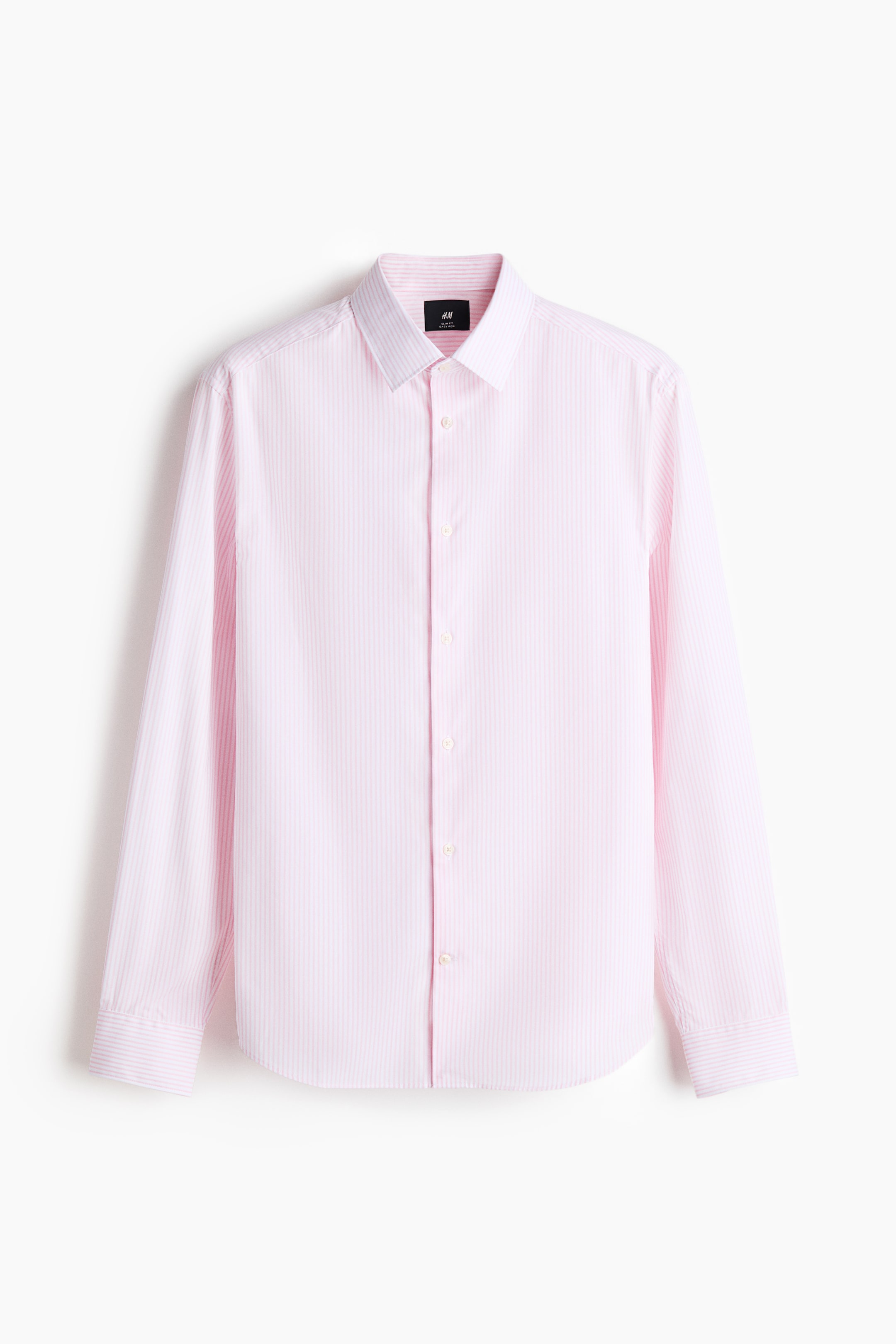 View larger image: FRONT: A pink shirt with fine white vertical stripes is hanging on a hanger, showcasing a slim fit and featuring a turn-down collar, a classic button-up front with white buttons, long sleeves with buttoned cuffs, a sleeve placket with a button, and a gently rounded hem.
