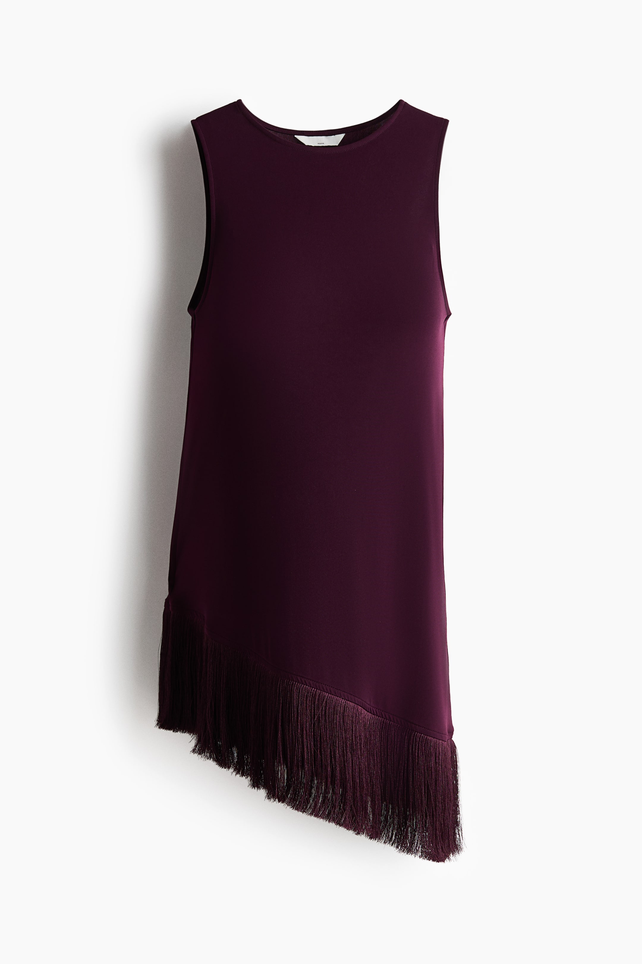 View larger image: A deep purple sleeveless top is shown from the front, featuring a round neckline and an asymmetrical hemline with matching fringe detailing adorning the longer side.