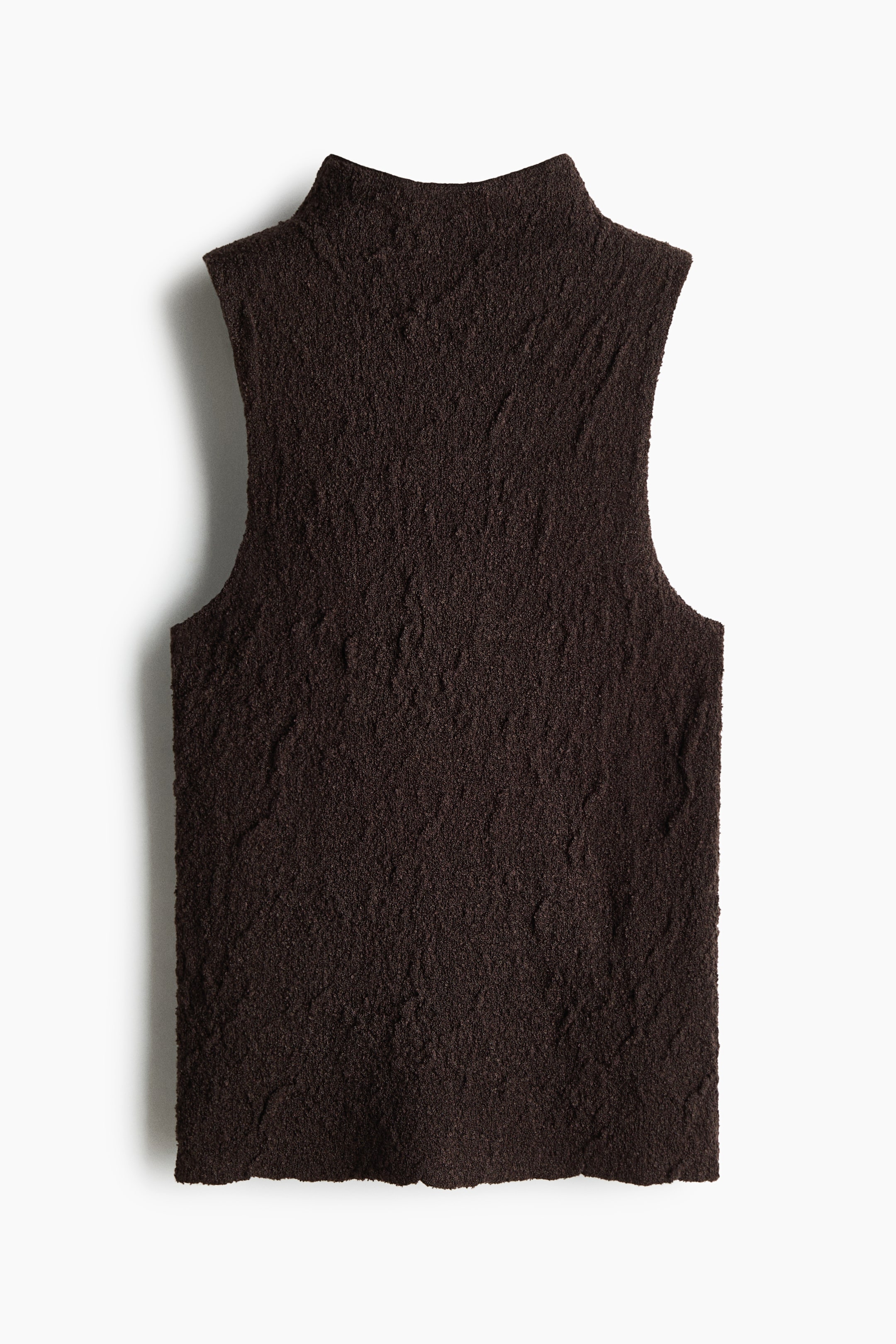 View larger image: A deep brown sleeveless top showcases a mock neck along with a richly textured, uneven surface, highlighting its front. The armholes of the garment are cut in, and the bottom hem flaunts an unfinished, wavy edge.