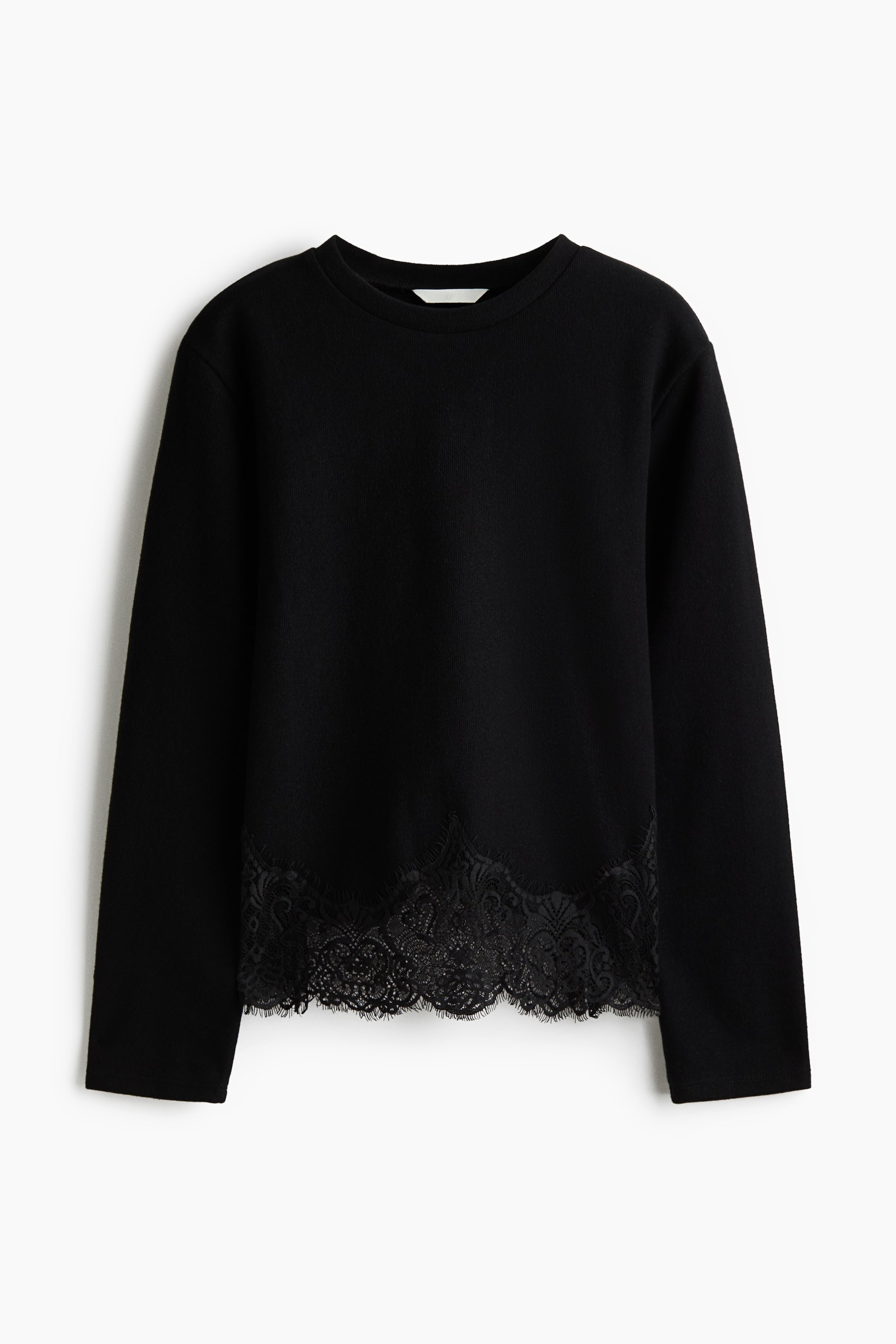 View larger image: A black, loose-fit jersey top is shown from the front, featuring a round, rib-trimmed neckline and long, straight sleeves. The design features a scalloped black eyelash lace trim along the bottom hem.