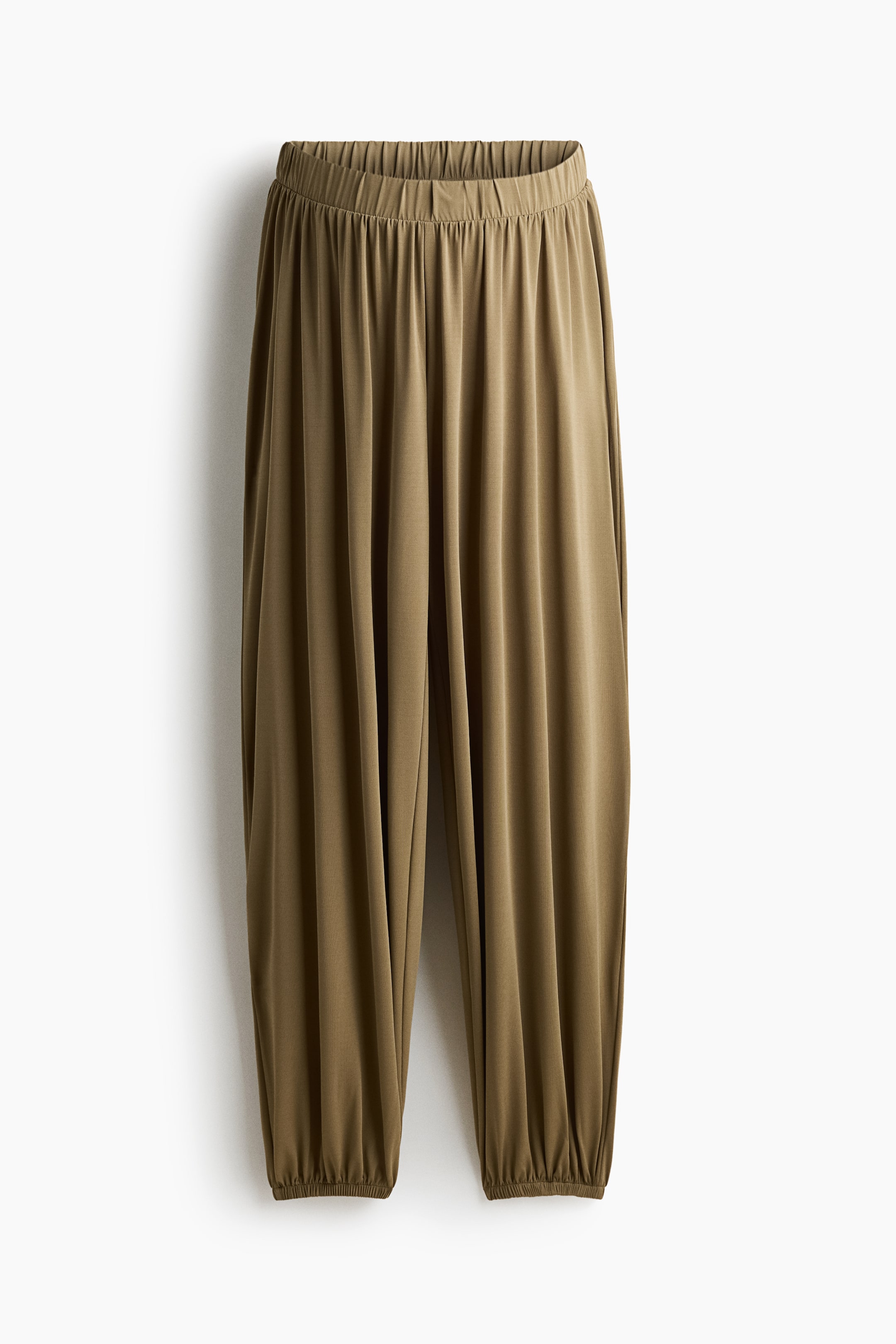 View larger image: The olive green pants feature a relaxed fit with an elastic, ruched waistband. The wide legs taper to elastic, ruched cuffs at the ankles.