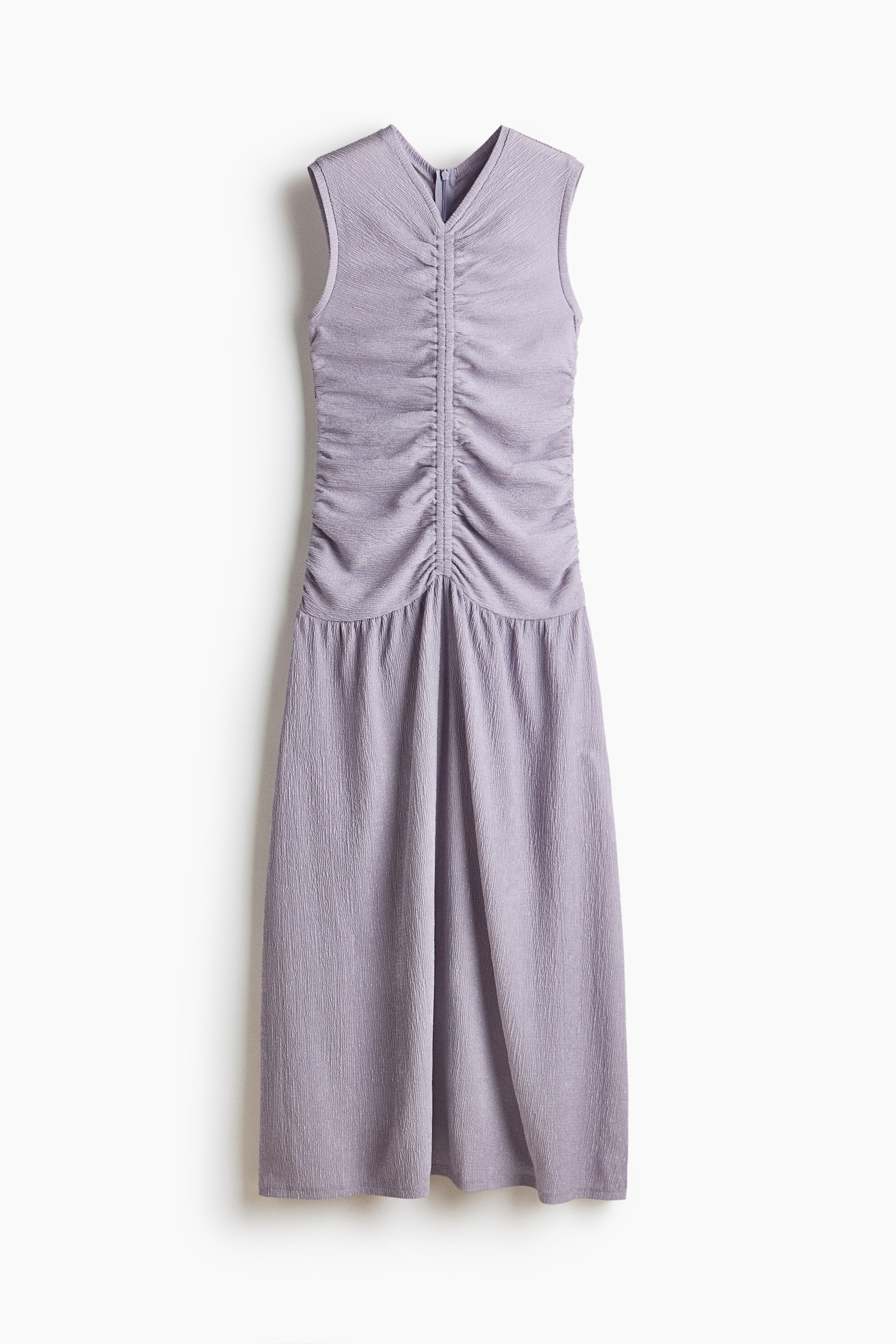 View larger image: The long, sleeveless lavender dress in crinkled jersey is displayed from the front, highlighting a V-neck and an elasticated seam at the front that creates gathers down the bodice. It also features a gathered seam below the hips, from which a flared skirt flows.
