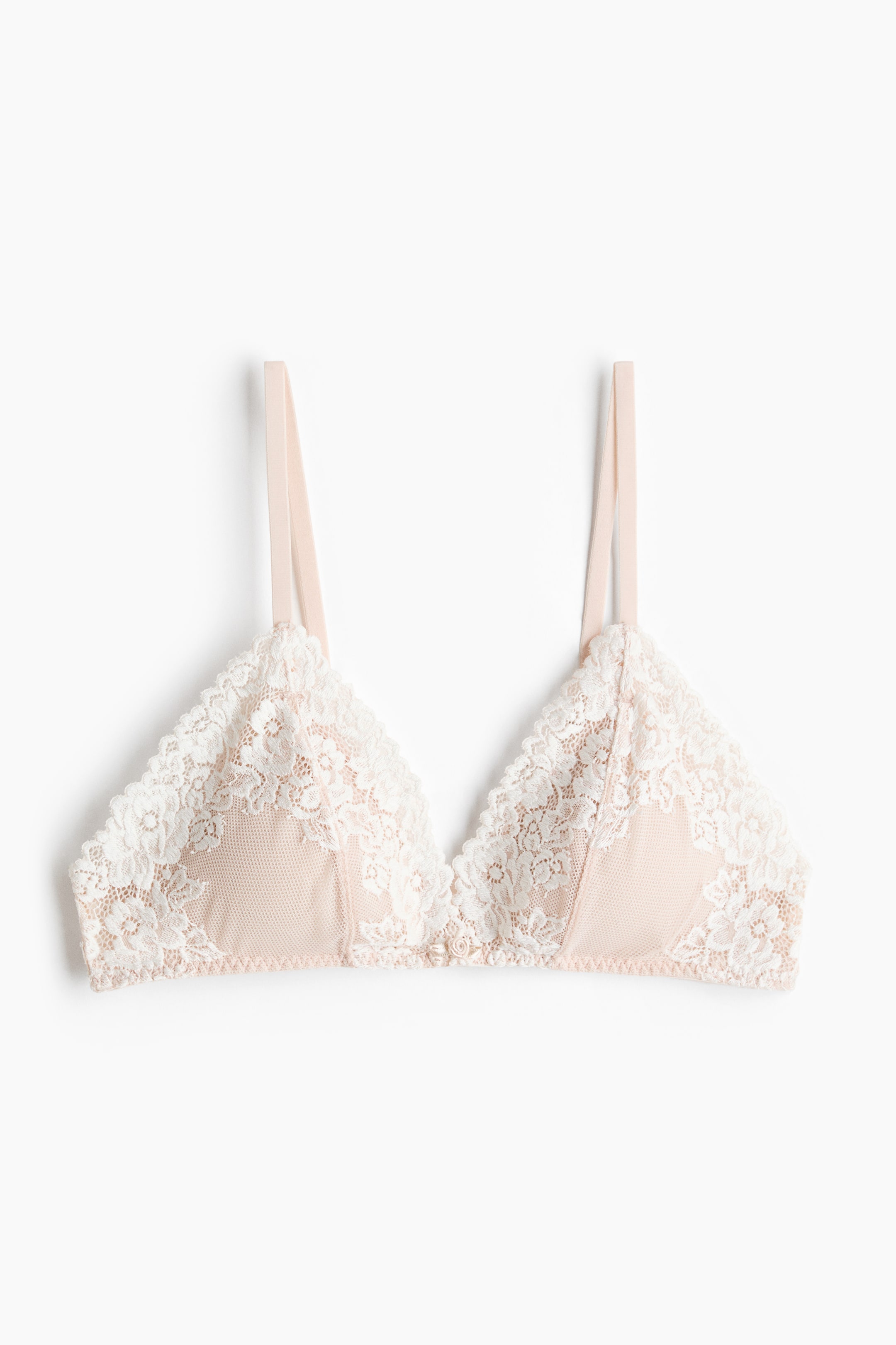 View larger image: A soft, wireless bra is shown from the front, featuring triangular cups with a light pink mesh base and a white floral lace overlay, along with thin, adjustable shoulder straps.