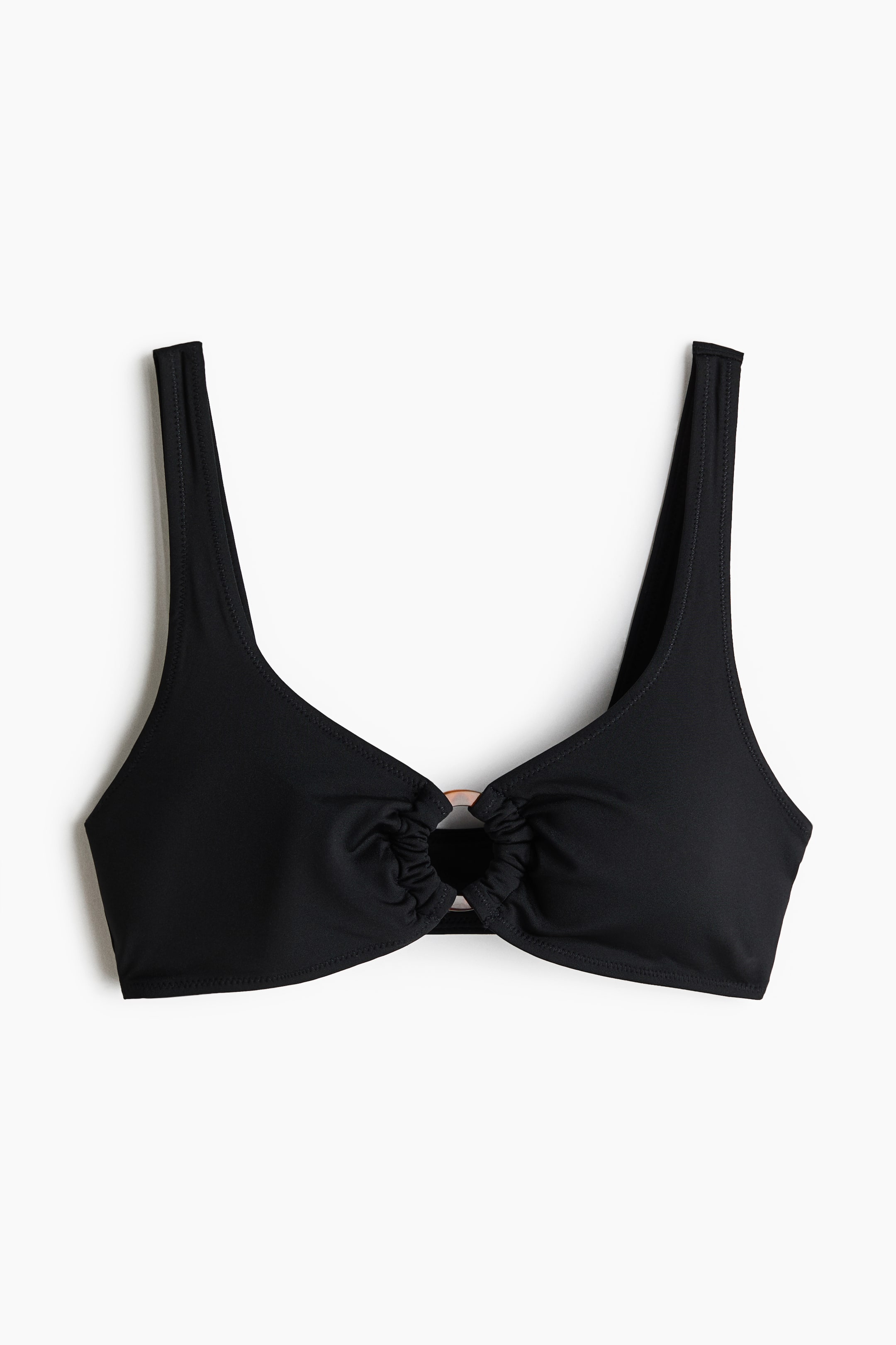 View larger image: A black bikini top is showcased from the front, featuring wide shoulder straps and a metallic O-ring at the centre, around which the fabric of both cups gathers.