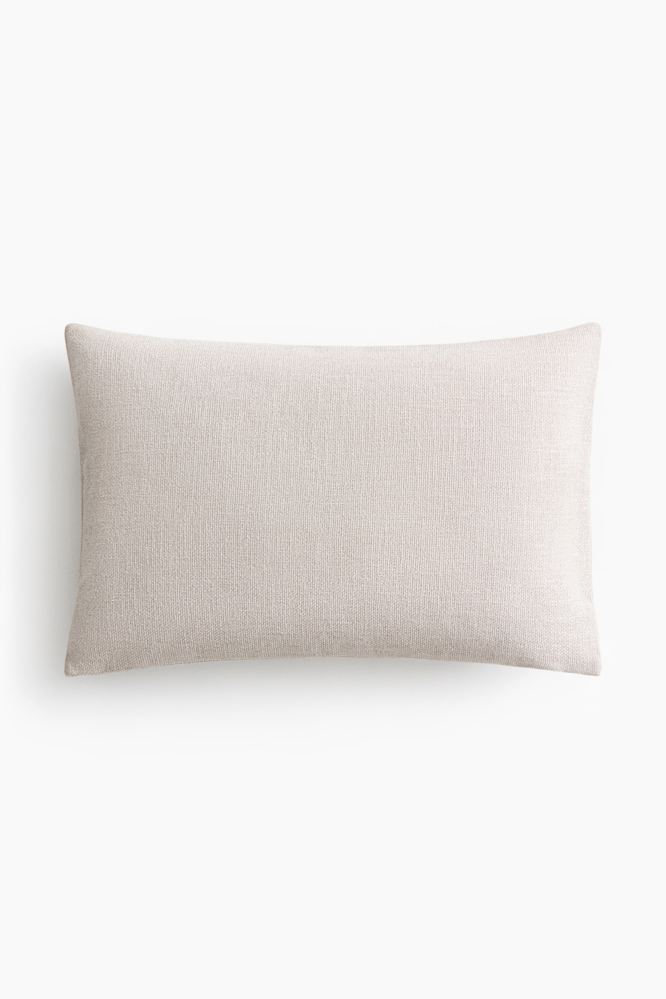 View larger image: A rectangular pillow lies horizontally, facing forward. It features a light beige color and a distinct woven texture.