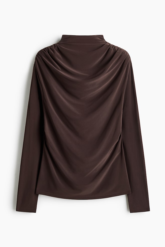 A dark brown, long-sleeved top featuring a high mock neckline and a dramatic cowl drape cascading down the back from the shoulders. The garment features long, straight sleeves and a clean, straight hemline. - 1