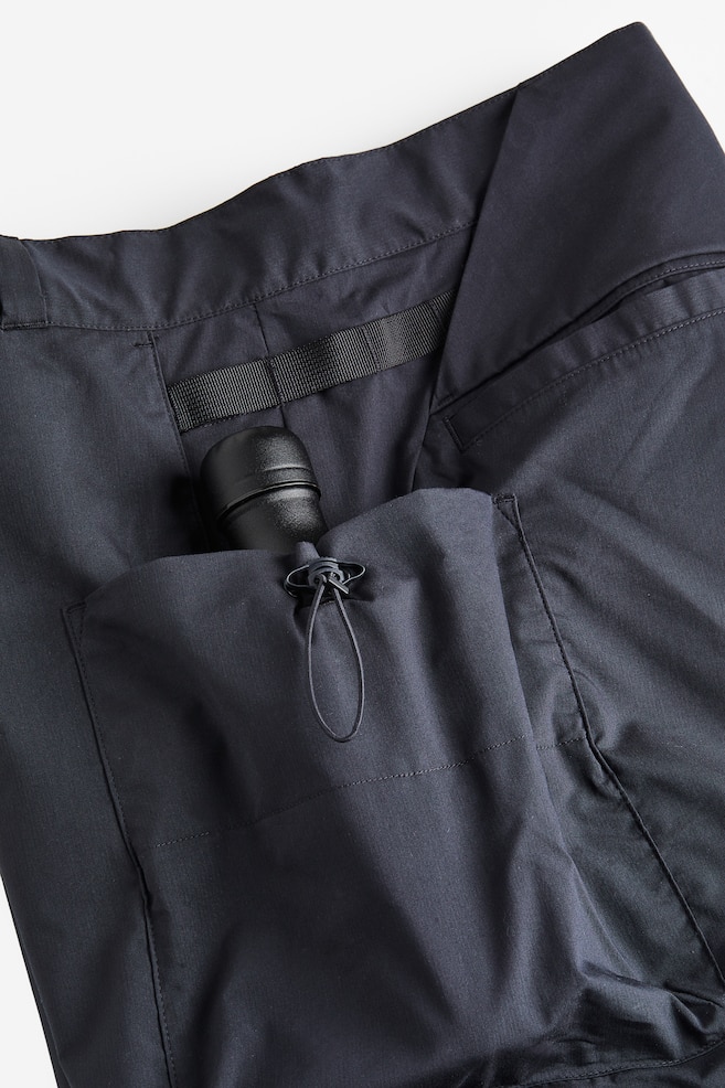 Water-repellent zip-off hiking trousers - Black/Brown - 11