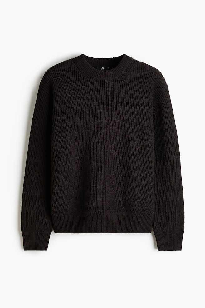A dark brown ribbed knit sweater is being displayed, featuring a crew neck and ribbed cuffs and hem. - 1
