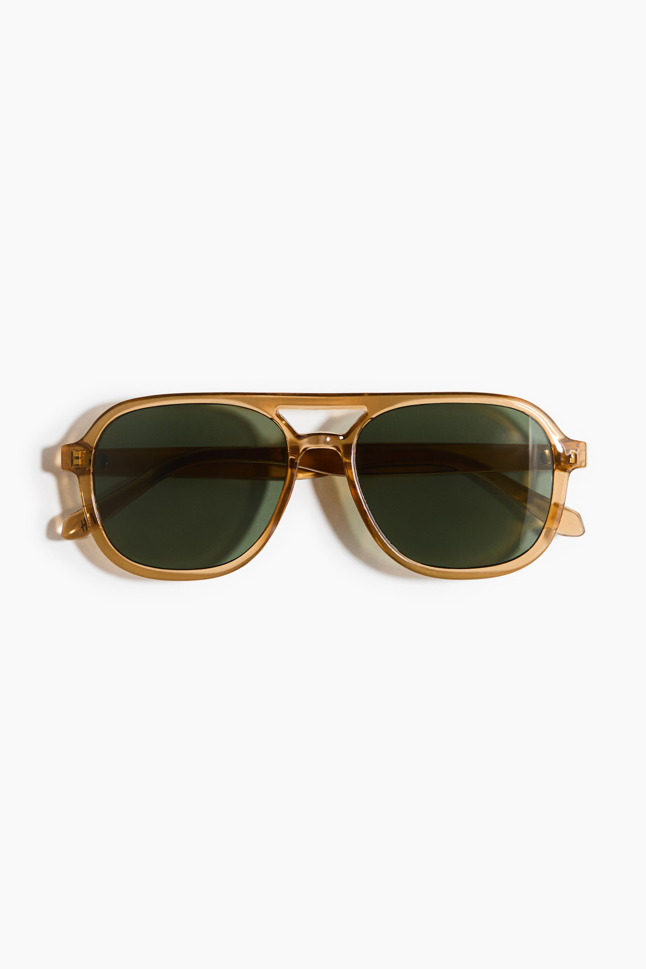 View larger image: "The sunglasses are showcased in a front-facing view, boasting translucent light brown plastic frames designed in an aviator-inspired shape with a double bridge. They come equipped with dark green, rectangular tinted lenses."