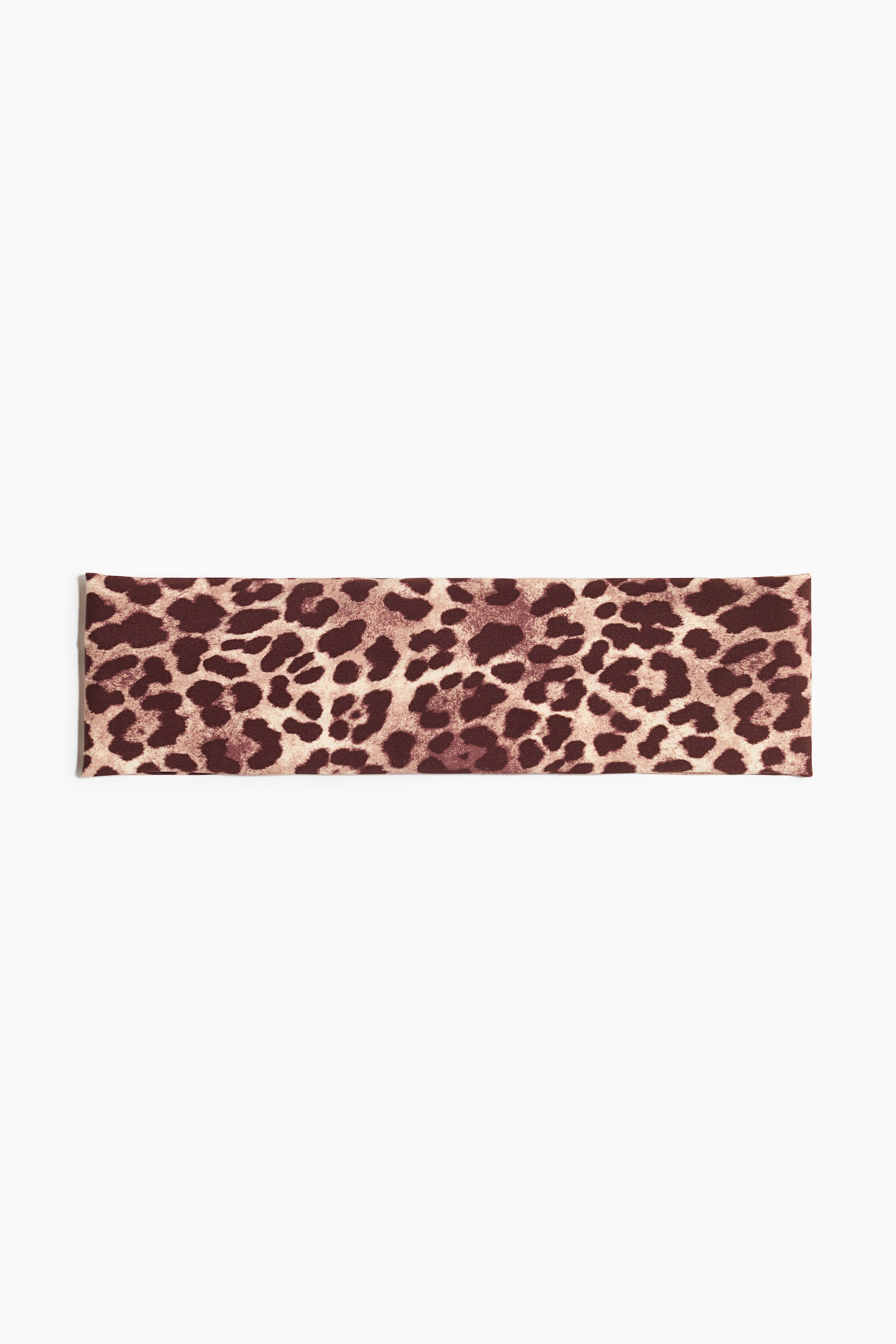 Ver imagen más grande: Una diadema de doble capa está colocada horizontalmente, mostrando un estampado de leopardo con manchas marrones sobre un fondo beige claro.