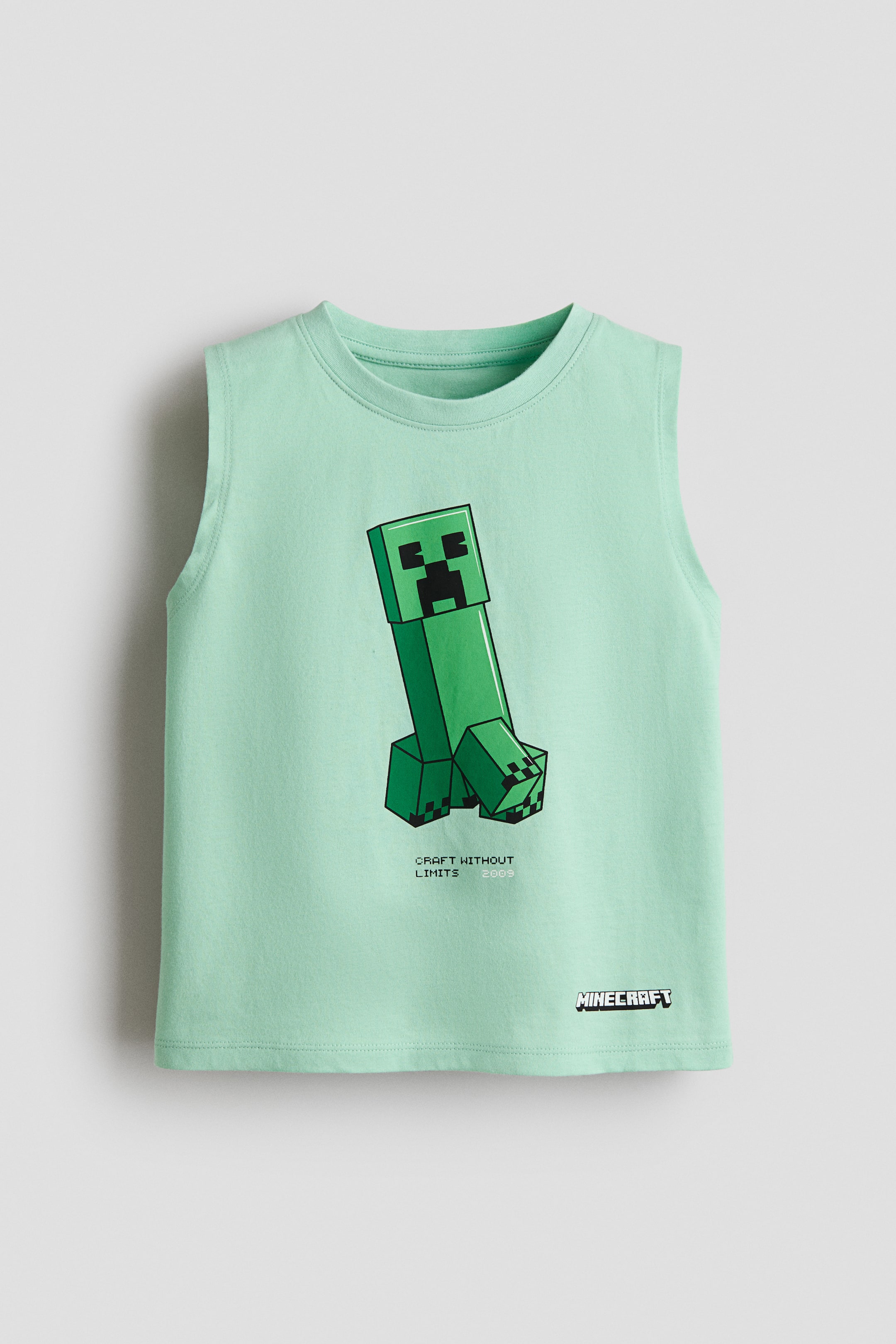 Büyük resmi görüntüle: Ön kısmında Minecraft'tan büyük bir yeşil pikselli Creeper karakter grafiği bulunan nane yeşili kolsuz üst. Grafik, karakterin altında "CRAFT WITHOUT LIMITS 2009" metnini içermekte ve "MINECRAFT" logosu sağ alt kenara yakın bir yerde yer almakta.
