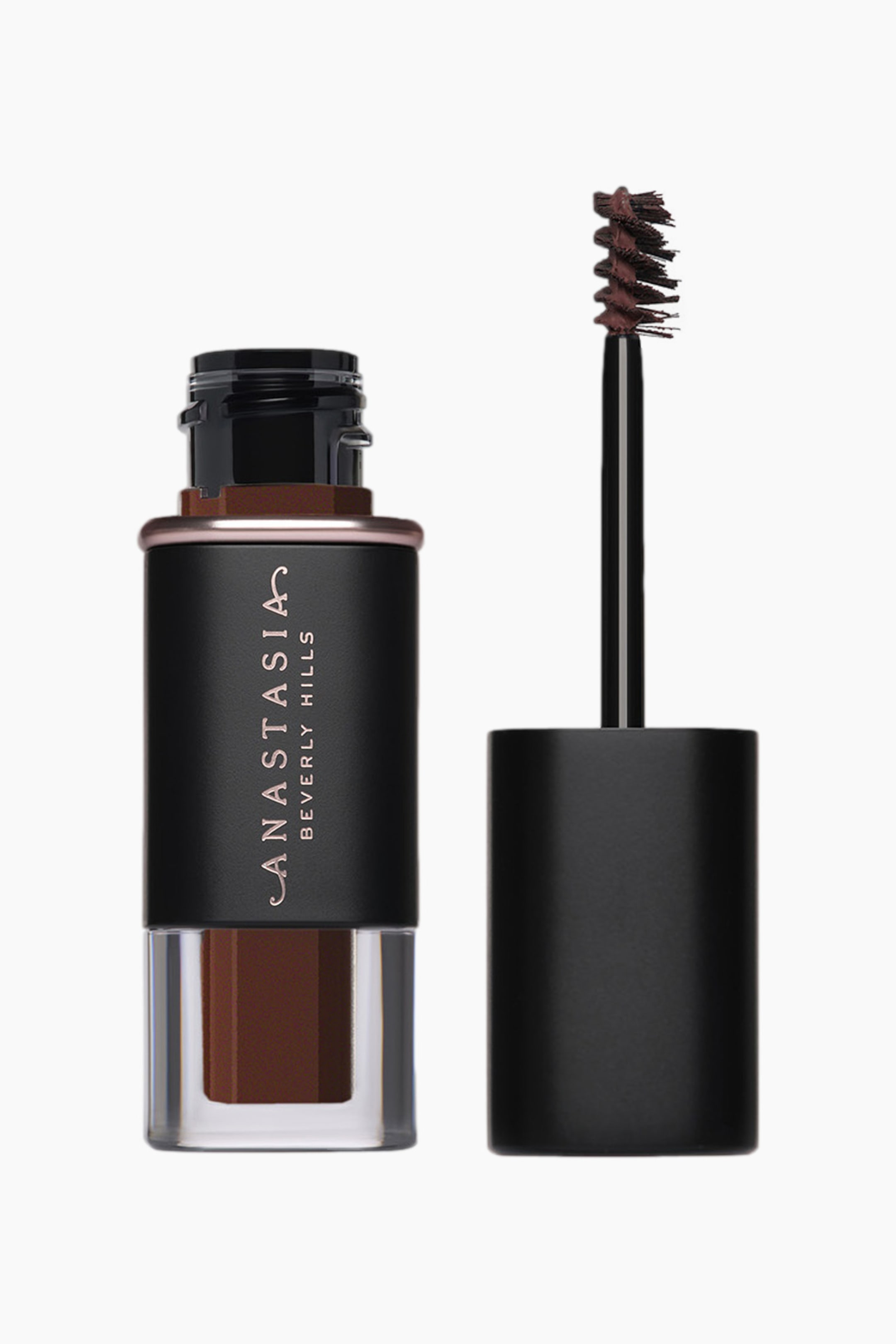 Vis større bilde: En beholder med bryngele fra Anastasia Beverly Hills står oppreist, med en svart øvre del med en rosegull-logo, et rosegull-bånd, og en klar nedre del som avslører mørkebrun gel. Den avtakbare applikatoren står oppreist ved siden av, og viser en mørkebrun spiralformet børste.