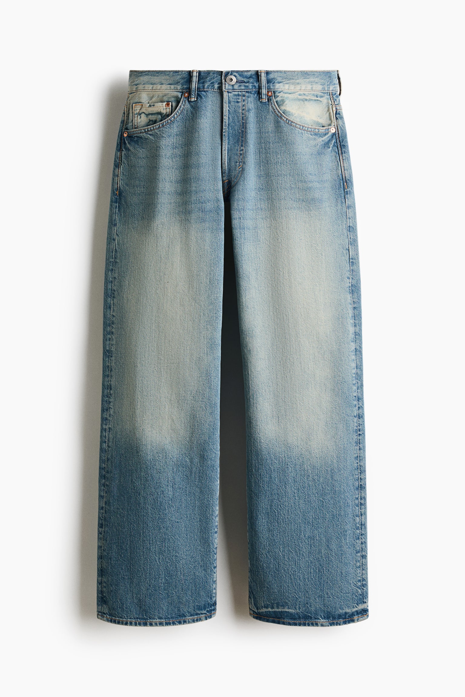 The front of these light blue denim jeans is showcasing a loose, wide-leg fit, appearing with a faded wash on the thighs and a darker tone on the lower legs. They are featuring a regular waist, a button closure, a zip fly, and visible curved front pockets with a coin pocket. - 1