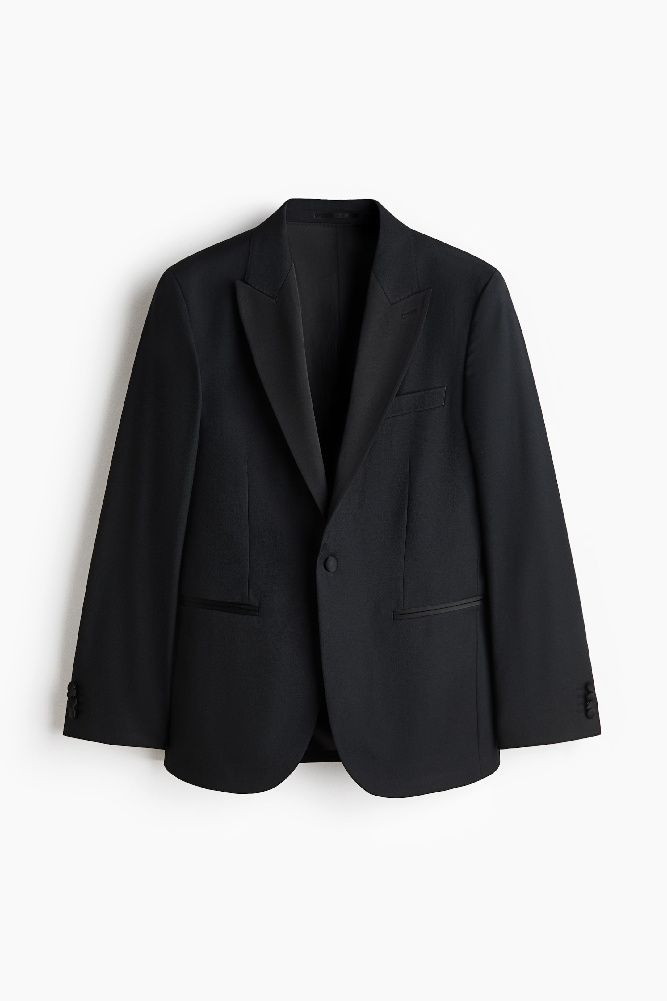 View larger image: A black tuxedo jacket features a single-button closure, satin shawl lapels, one welt chest pocket, and two jetted pockets with satin trim. Four decorative buttons adorn each cuff.