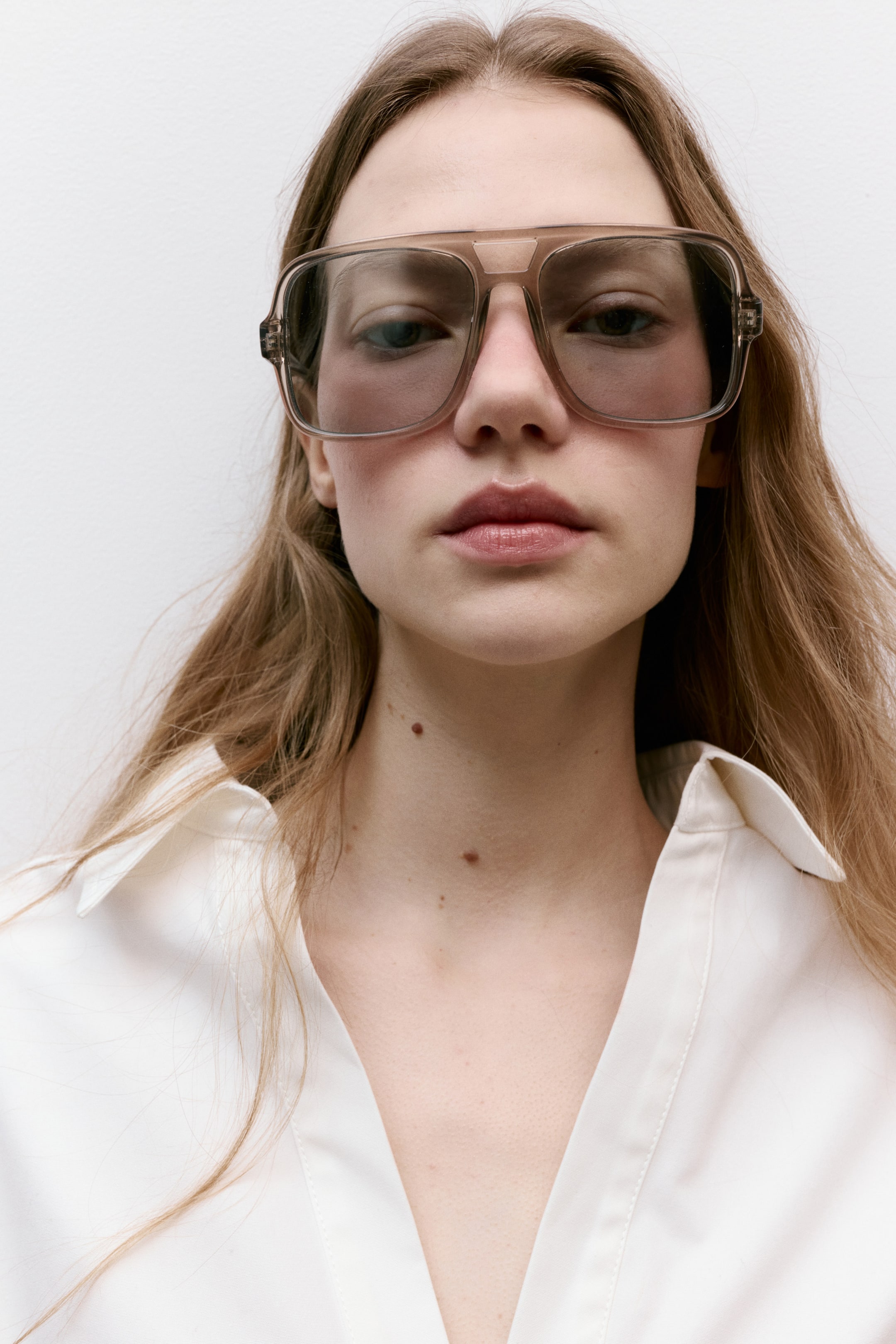 View larger image: Large aviator-style sunglasses feature a translucent brown plastic frame with tinted lenses, showcasing a double bridge design.