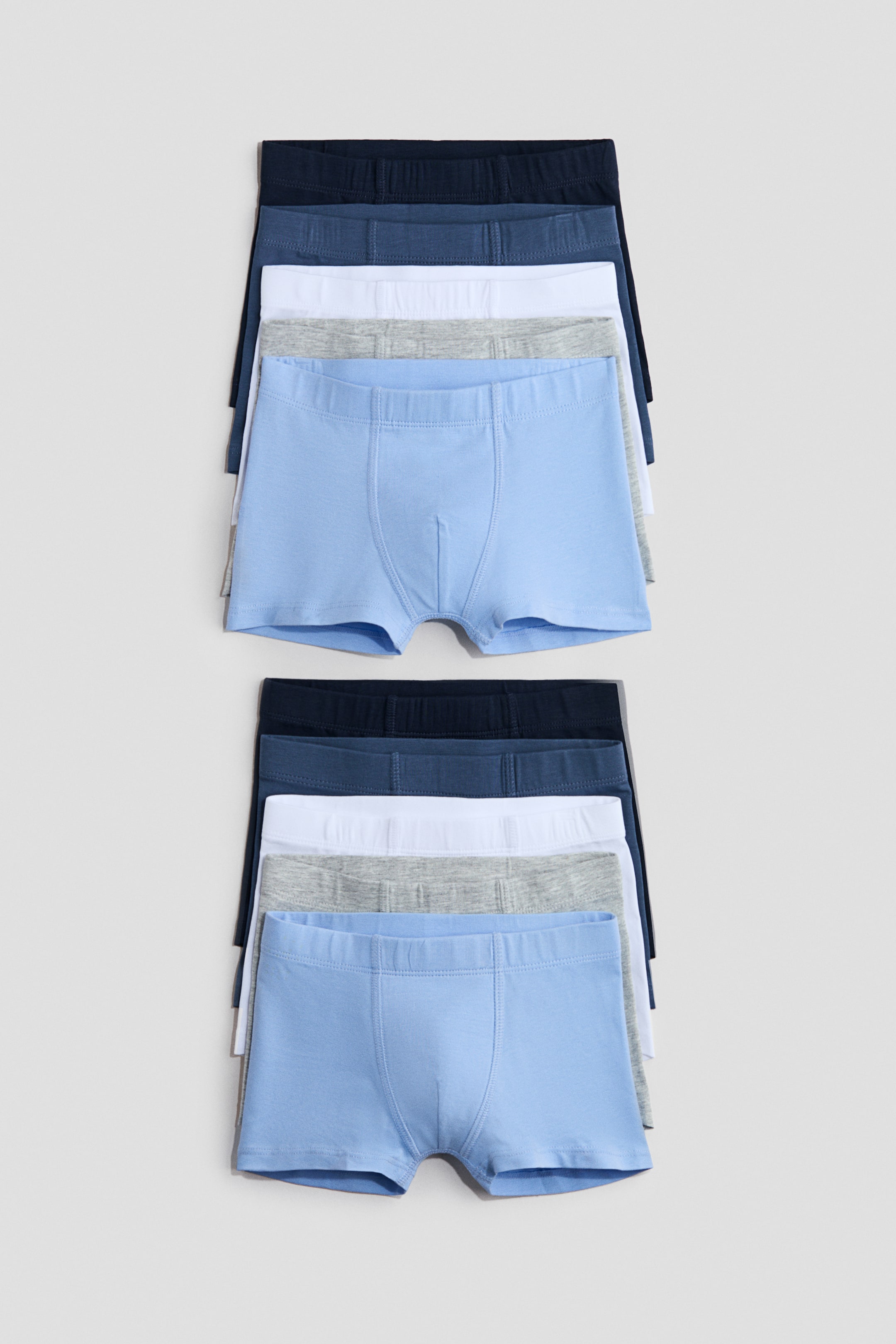View larger image: The boxer briefs are neatly arranged in two stacks, each comprising five pairs. The top pair in light blue is prominently displayed, showcasing its front with an elastic waistband and a contoured pouch. Meanwhile, the grey, white, medium blue, and dark blue pairs subtly peek out from beneath.