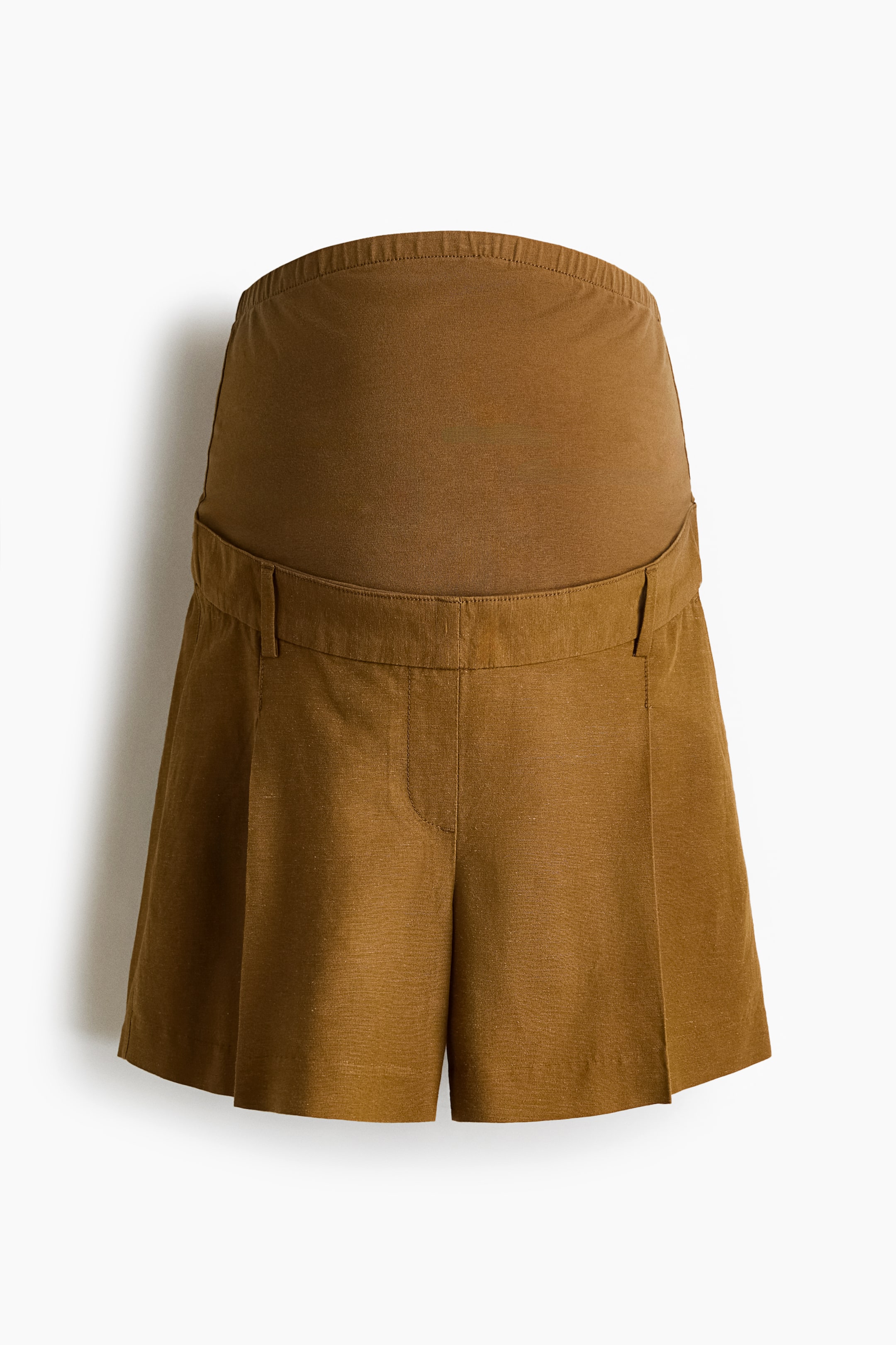 View larger image: A pair of brown tailored shorts is facing front, featuring a wide brownish-orange jersey panel at the waist. The shorts showcase a faux fly, diagonal side pockets, front pleats, and visible creases, all crafted from an airy weave.