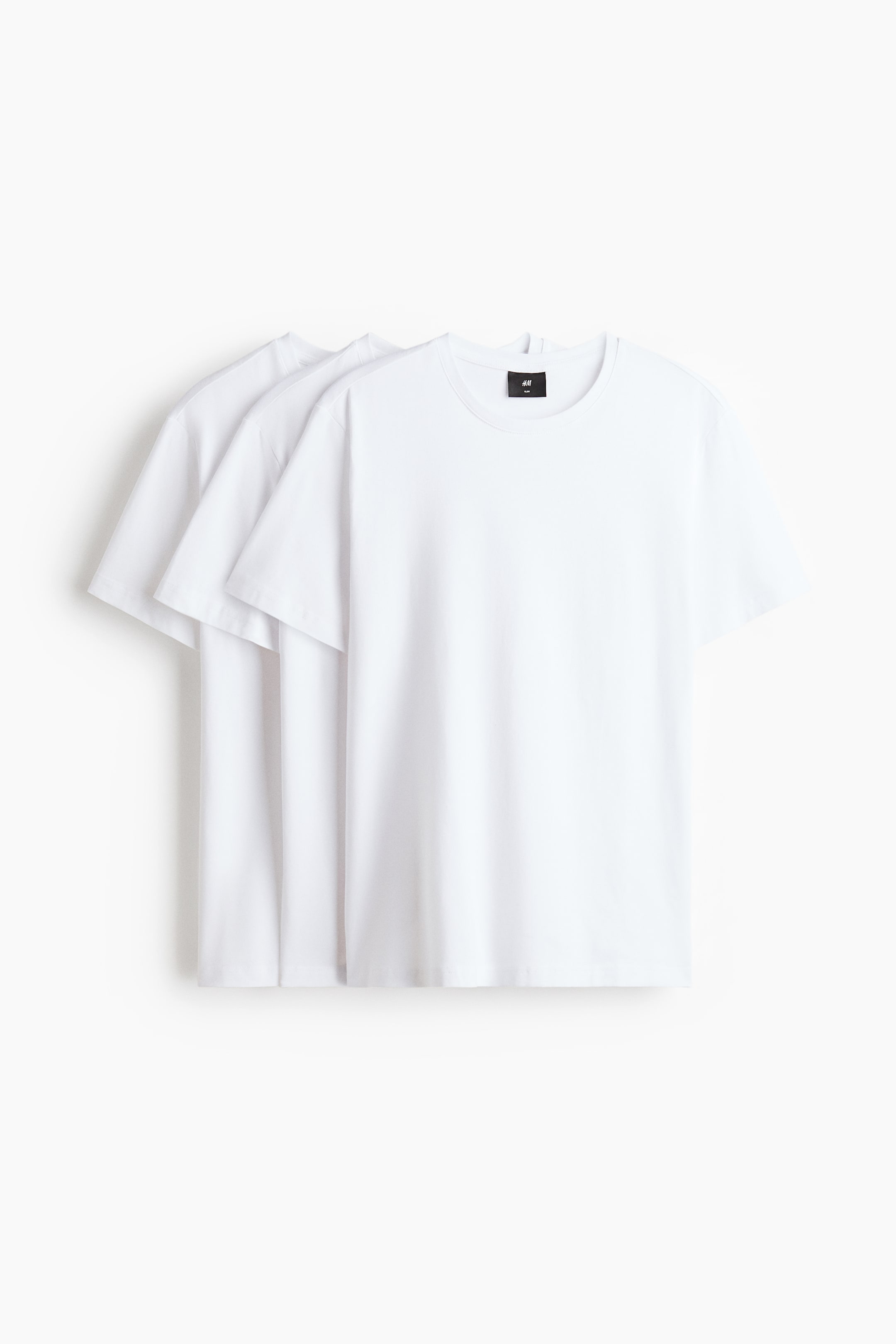 View larger image: Three white t-shirts are shown from the front. The front t-shirt features a round, ribbed neckline, short sleeves, and a straight-cut hem, highlighting a slim, fitted silhouette.