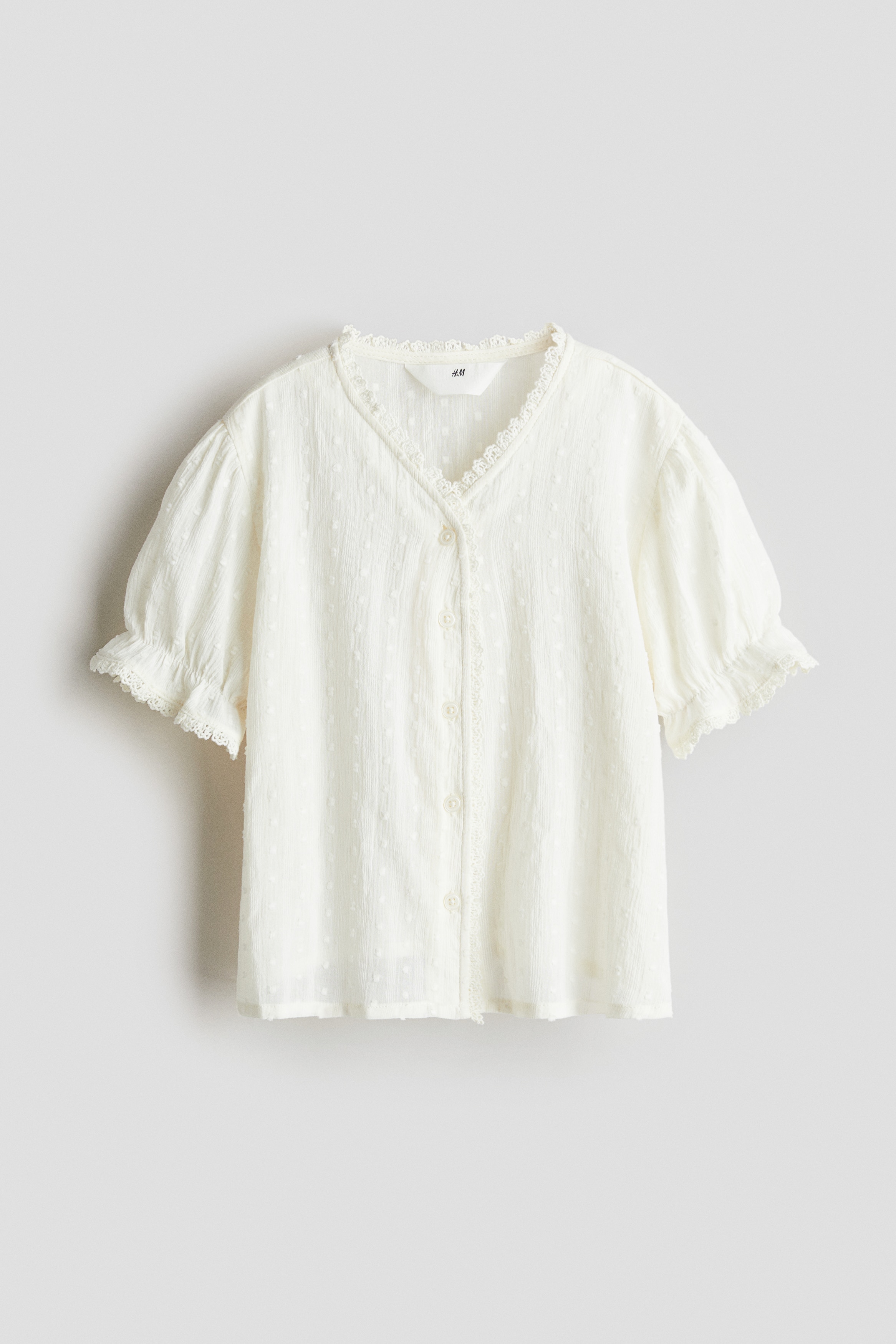 Blusa de algodón con borde de encaje - Crema