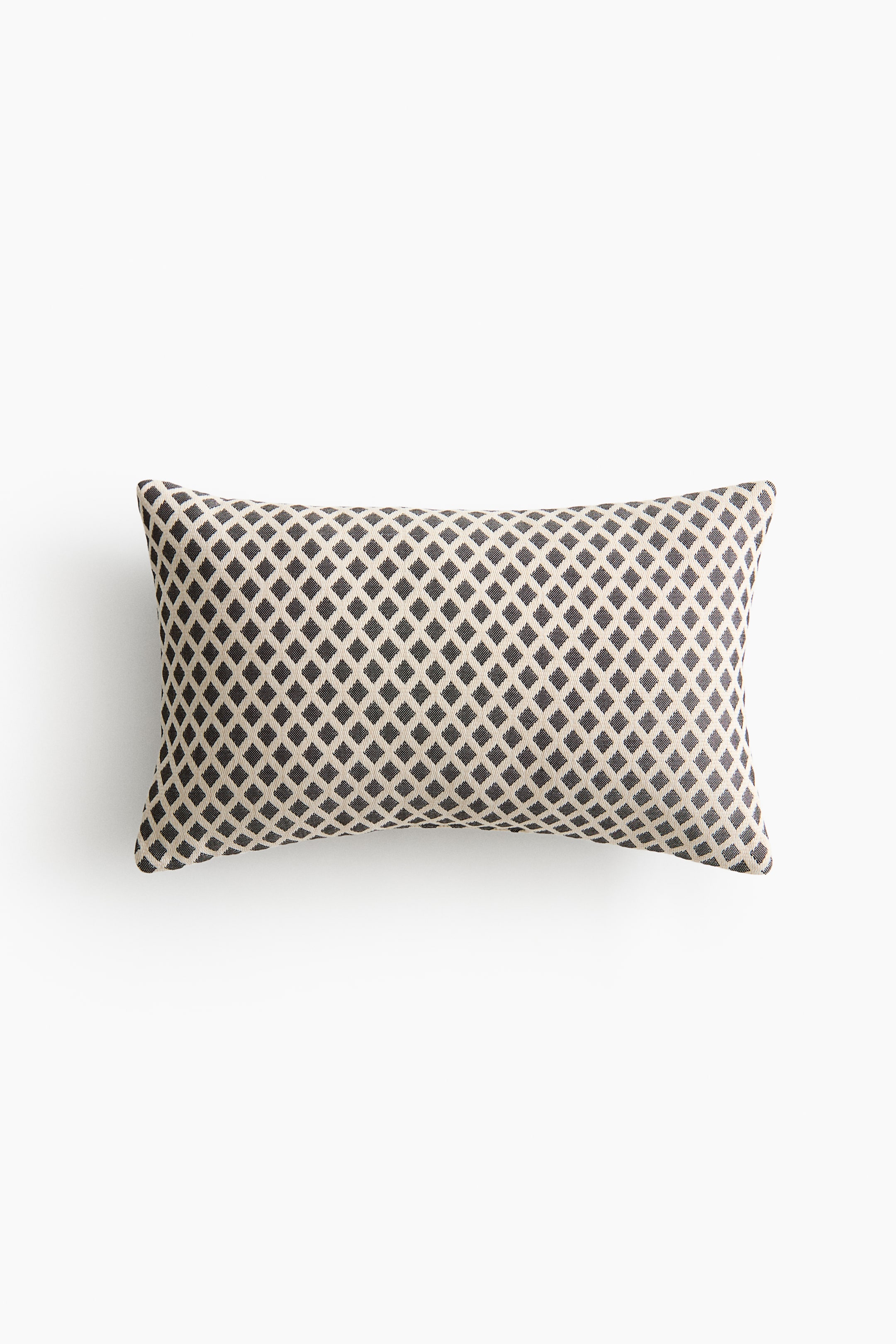 View larger image: A rectangular cushion is showcasing its front side, adorned with a repeating diamond pattern of dark brown diamonds on a light beige background.