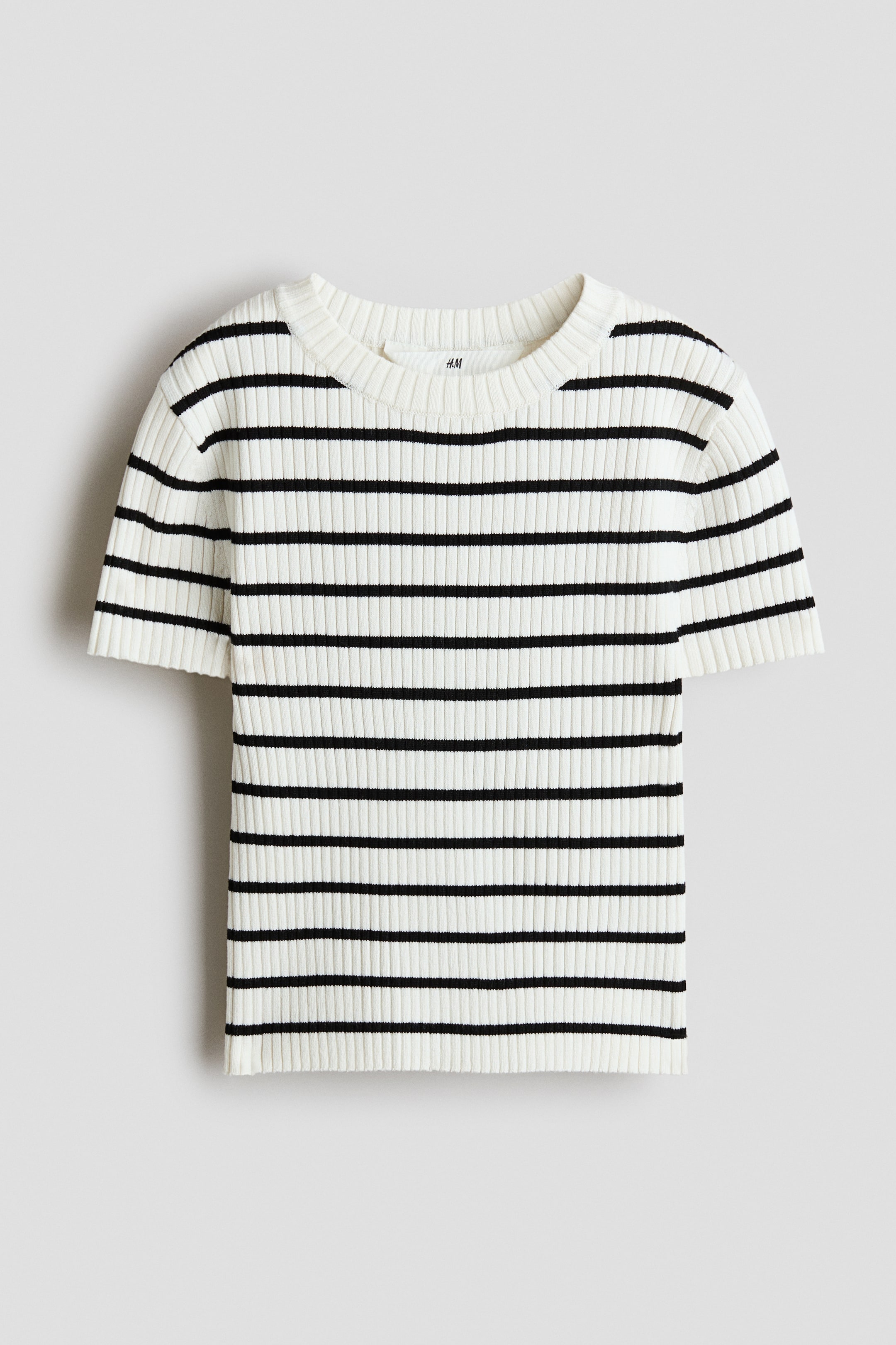 查看大圖: 短款上衣正面展示，採用柔軟羅紋針織面料，呈現黑白橫條紋；設計為圓領與短袖。