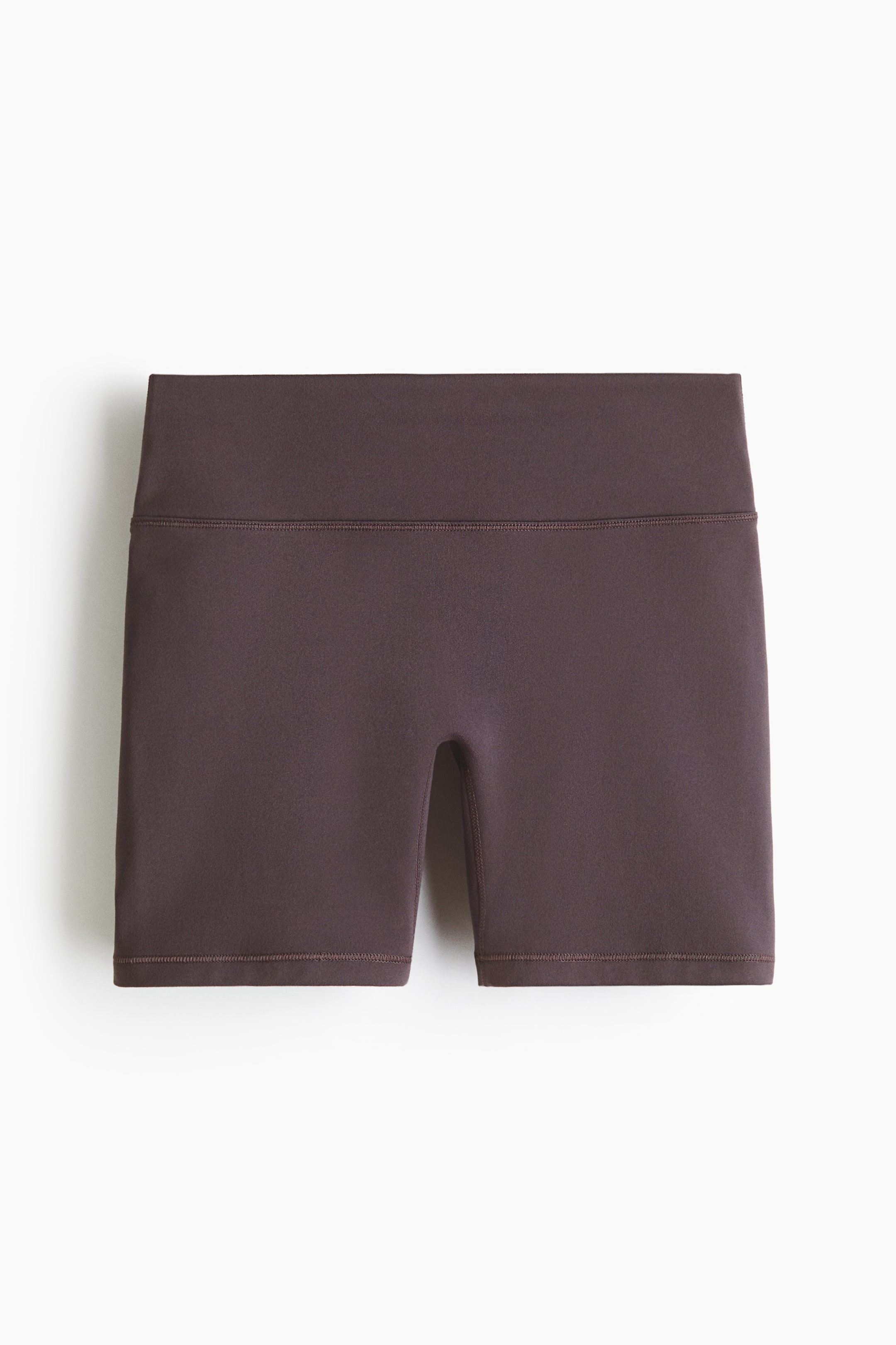 Grösseres Bild ansehen: Sport-Radshorts mit SoftMove erscheinen in einem dunklen Taupe-Ton, von vorne betrachtet. Sie verfügen über einen breiten, hochgeschnittenen Bund mit einer sichtbaren horizontalen Naht, und Flatlock-Nähte zieren die Beinabschlüsse und den Bund, wodurch ein glattes, figurbetontes Erscheinungsbild entsteht.