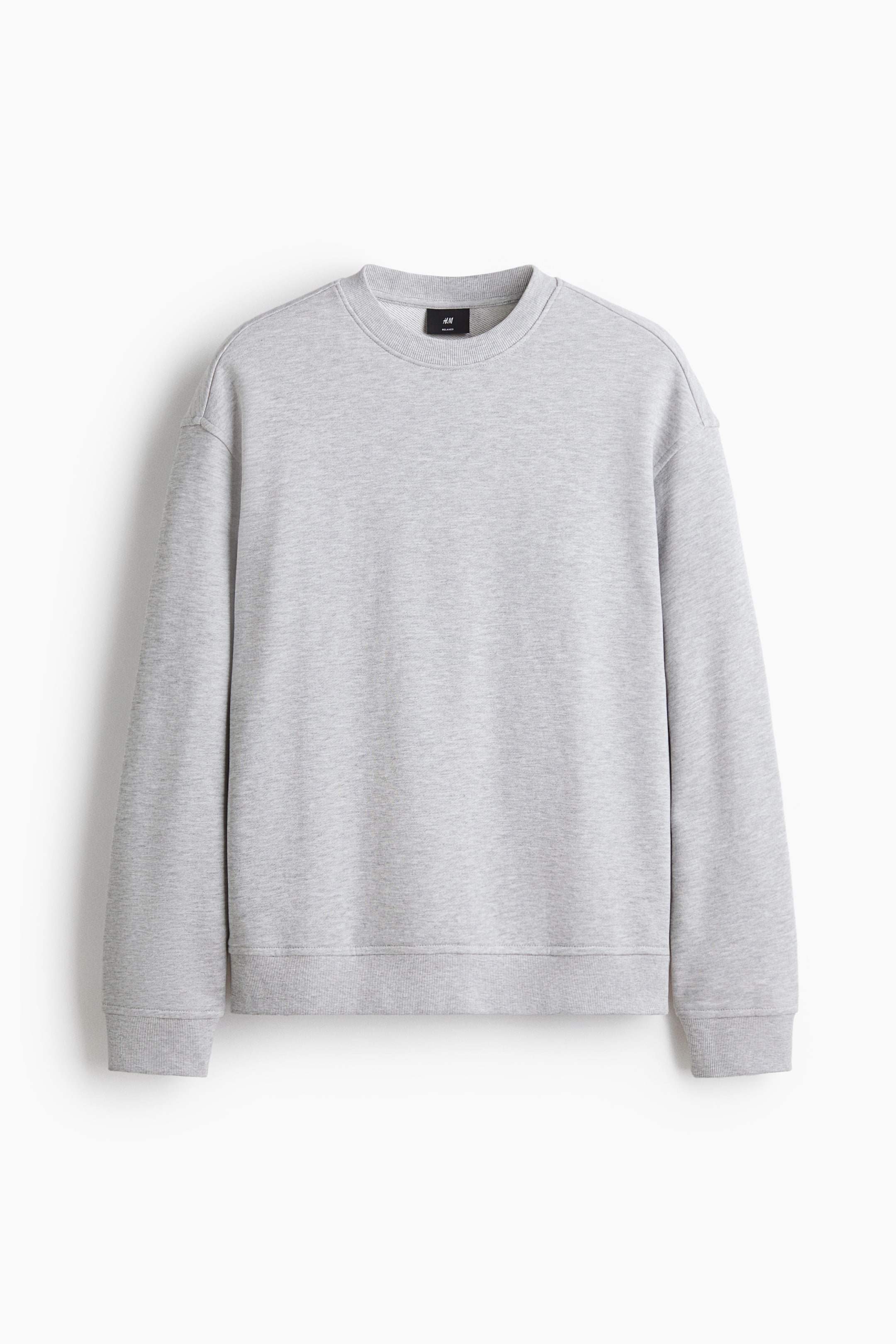 View larger image: The light grey sweatshirt showcases its casual fit from the front, highlighting a round neckline with ribbed trim, dropped shoulders, and long sleeves with wide, ribbed cuffs and hem.
