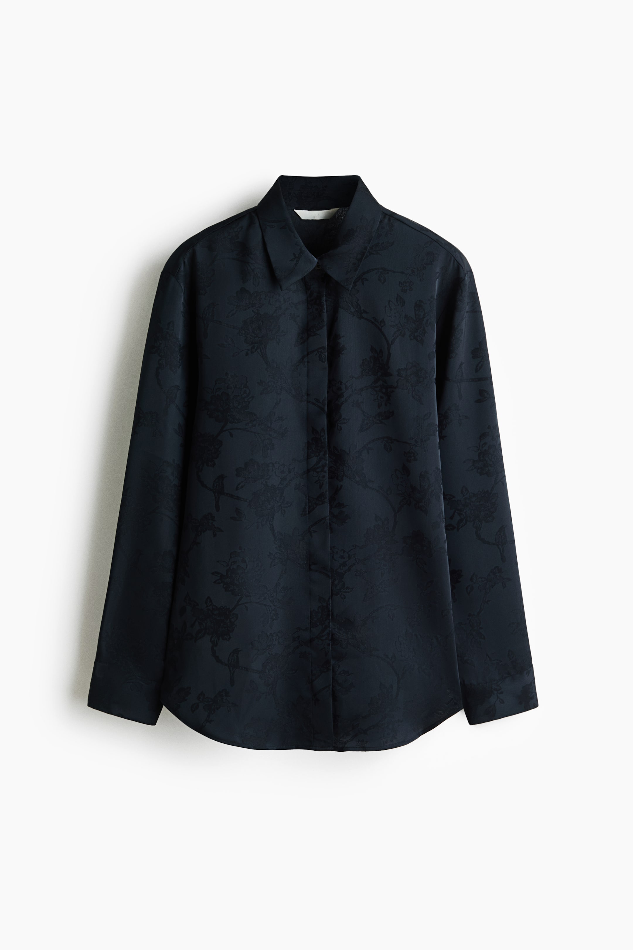 View larger image: A dark blue long-sleeved shirt with a subtle all-over floral and bird jacquard pattern is facing front. It features a pointed collar and long sleeves with standard cuffs.